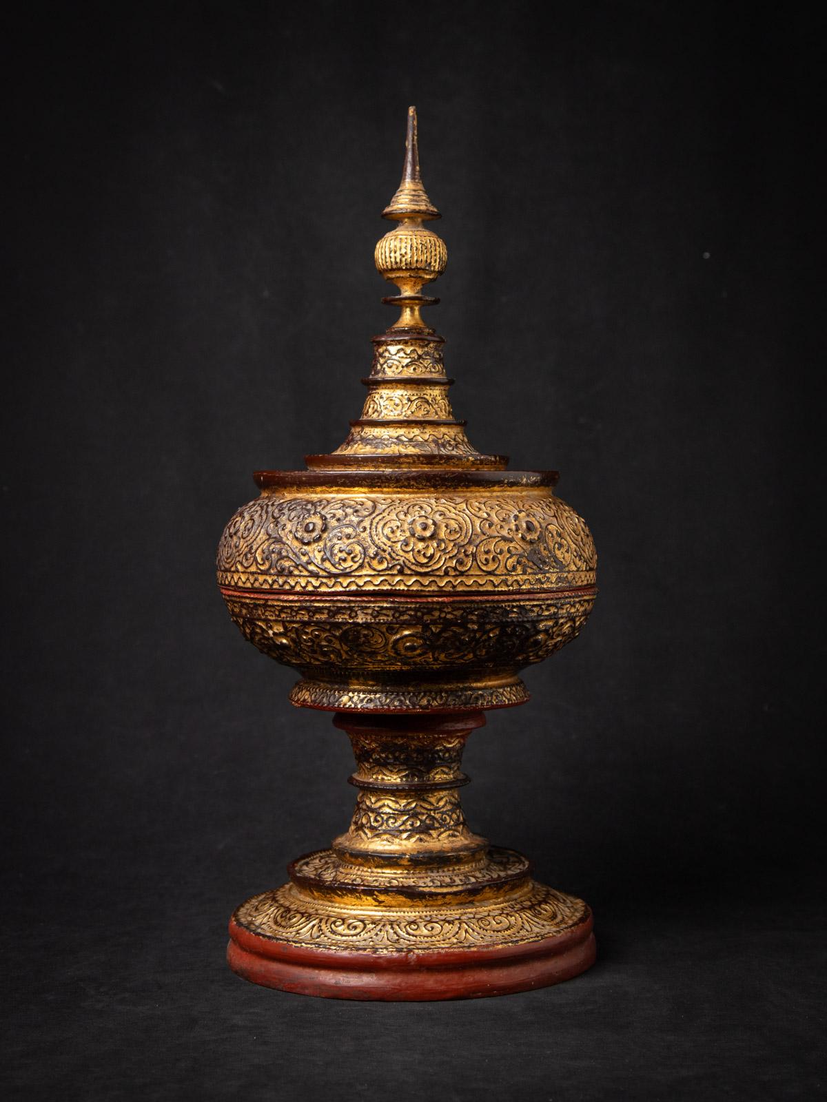 Unveil the splendor of this Antique wooden Burmese offering vessel, a 19th-century masterpiece from Burma (Myanmar) that harmonizes sacred artistry with the opulence of Mandalay-style craftsmanship. Standing 51.5 cm high with a 23.2 cm diameter,