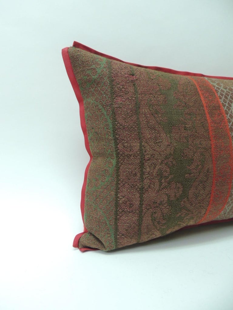 19th century antique woven red Kashmir paisley bolster decorative pillow.
19th century antique woven red and green Kashmir stripes decorative long bolster pillow with red silk ribbon trim and red carriage cloth fabric backing.
In shades of brown,