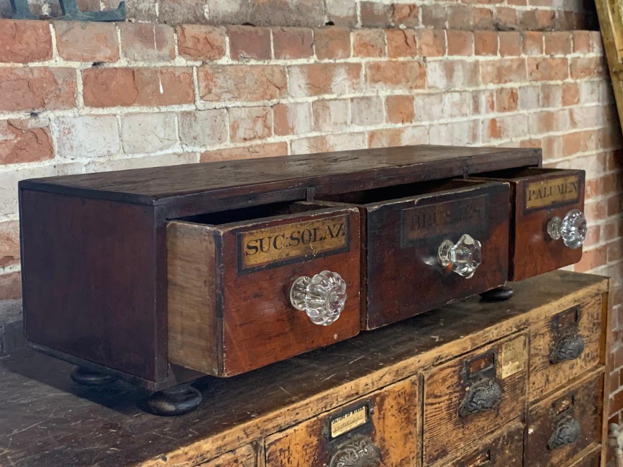 A nice small set of 19th century apothecary drawers with original labels and glass handles. In a purpose made cabinet.