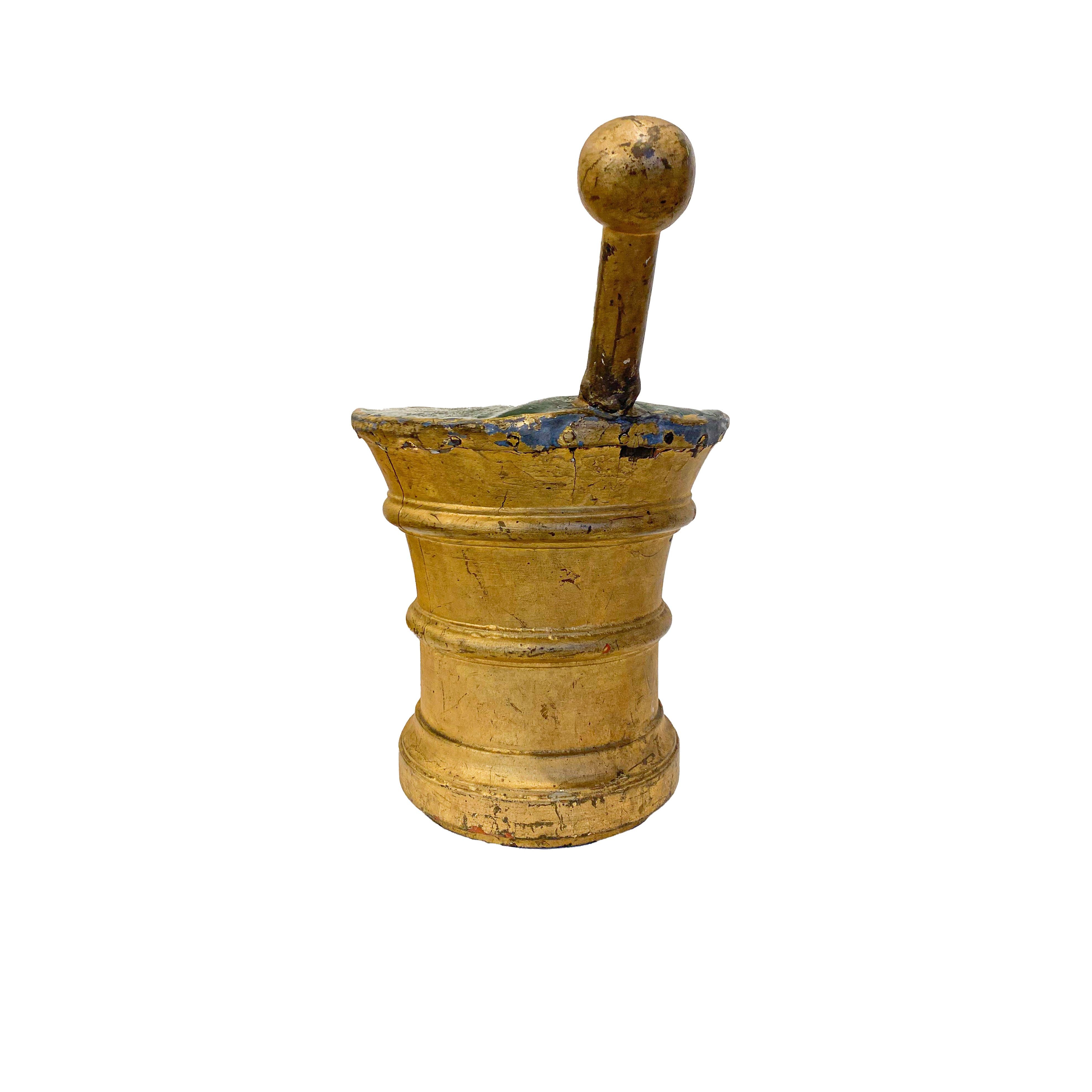 Figural trade sign in the form of a mortar and pestle, both the mortar and pestle are hand turned and gilded, with strong ring turnings. The top is capped with zinc and still bears in service green paint. The gilding has a remarkable warm patina.