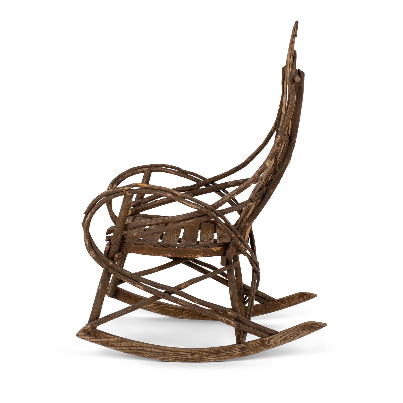 19th century Appalachian rocking chair constructed from twigs, bentwood and an oak seat. Faint remnants of old paint. Excellent condition and beautiful natural patina.