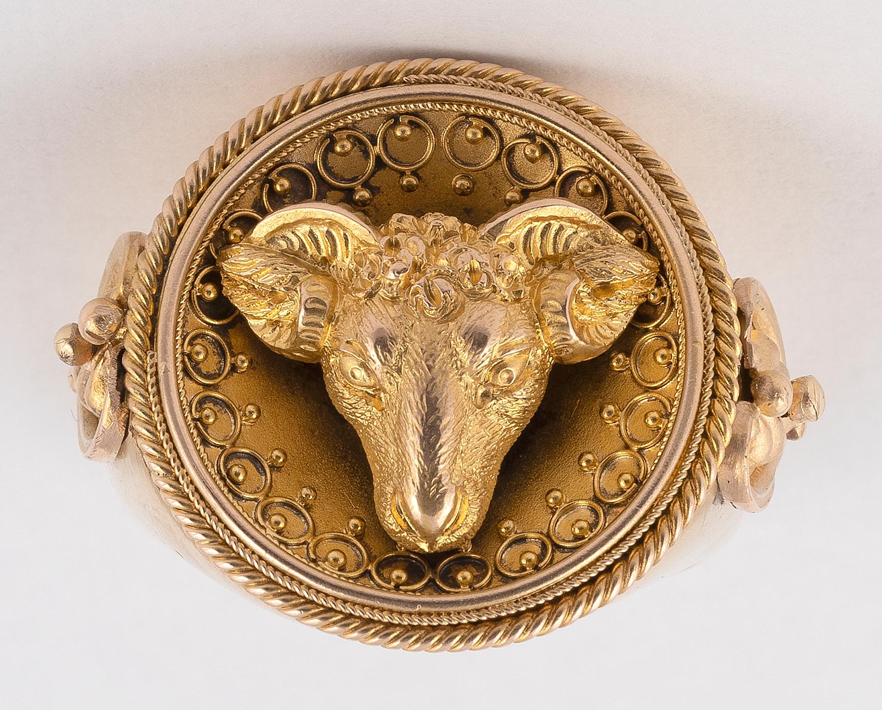 Possibly by Streeter & Co, depicting a ram's head within circular centre section, with beaded and wirework decoration within ropetwist border in yellow gold.
Size 7