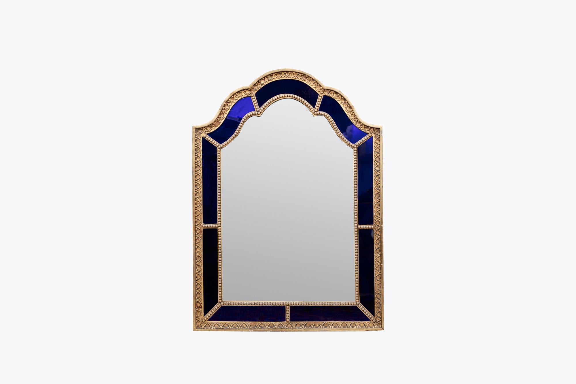 19th Century arched blue glass gilt-composition mirror. The deep cobalt blue border glass frame with gilt stiff-leaf and beaded border, surrounding shaped bevelled plate. The plate is set within a reverse-painted gold-speckled cobalt blue glass