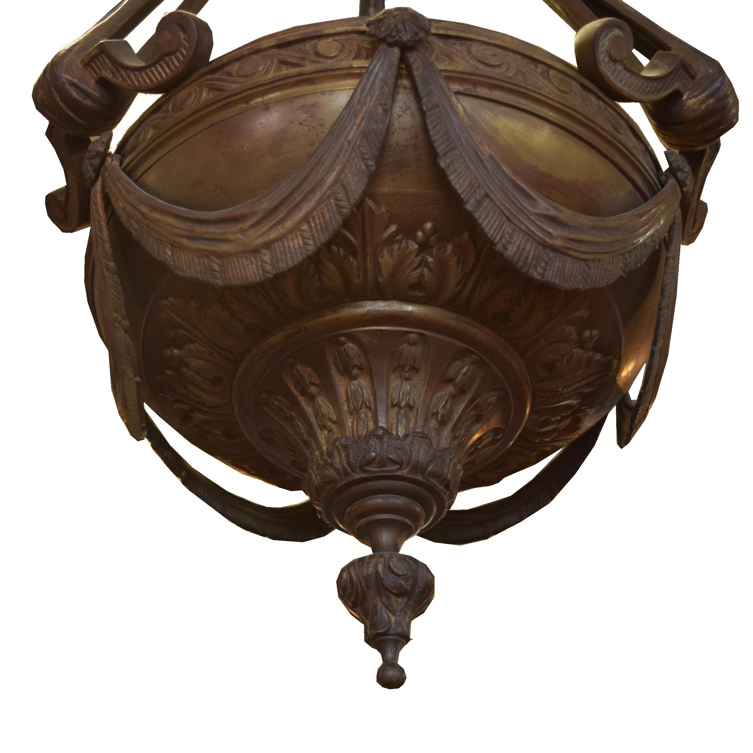 A beautifully cast bronze hanging light fixture with a bowl held by ribbons, all cast in bronze.
Required wiring.
