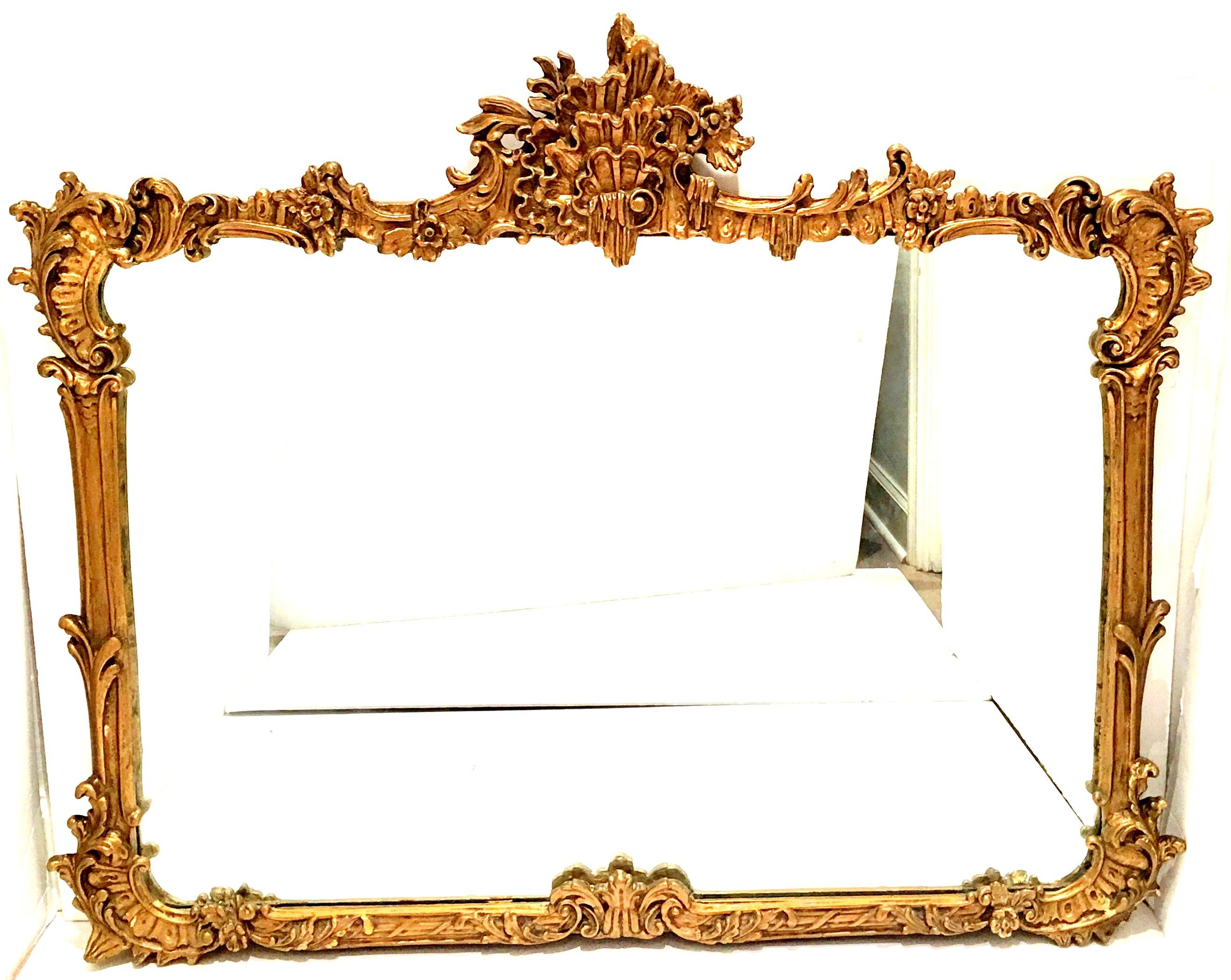 19th Century French Art Nouveau Style highly carved gold gilt wood and composition ornament  framed mirror. This substantial and heavy mirror features classic acanthus, floral and foliate detail with a large foliate three dimensional crown. Original