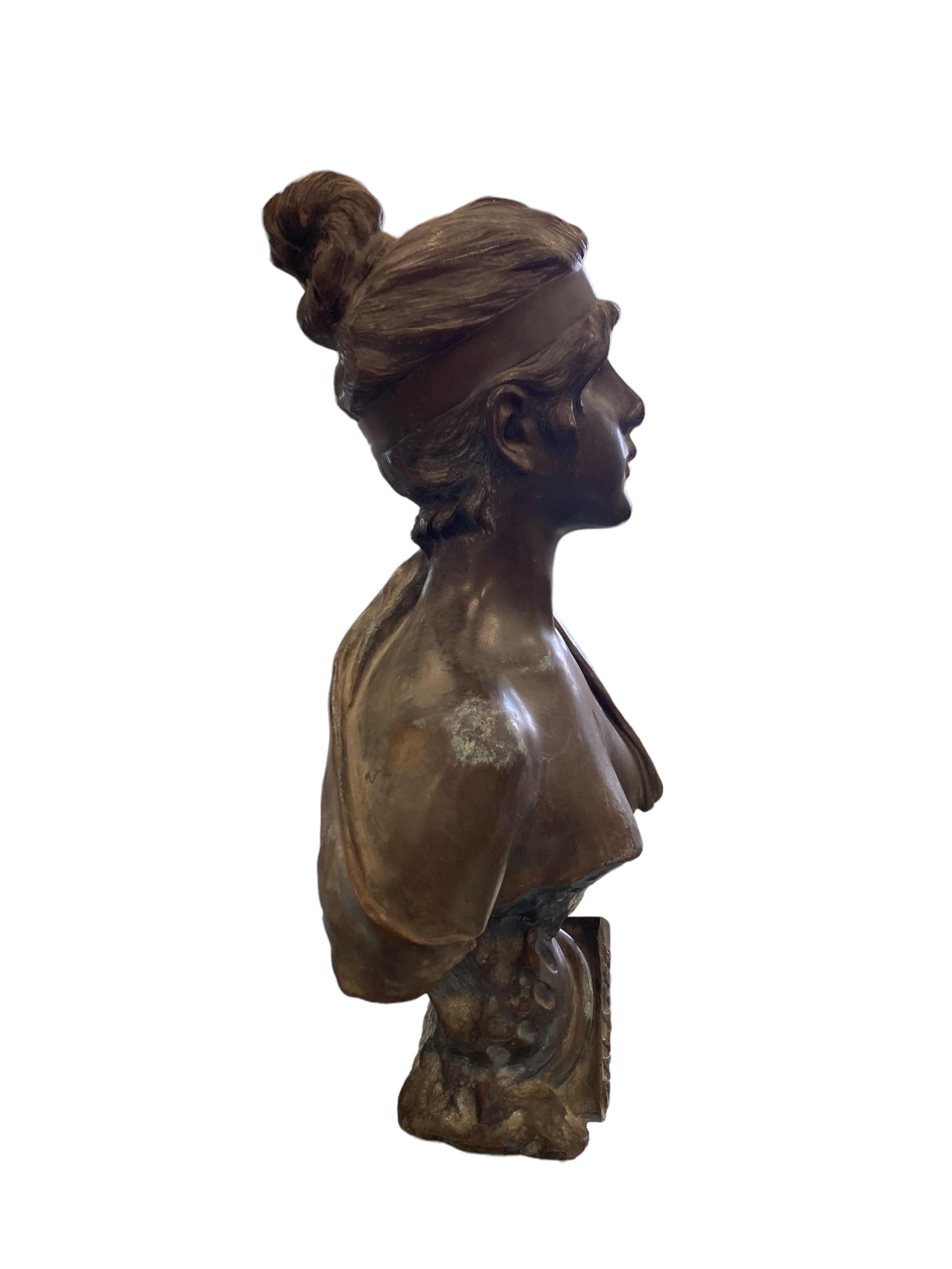 Galatée by Emmanuel Villanis is a beautiful, patinated bronze bust, sculpted, circa 1895. She modeled as a young woman, with her hair in a bun and a robe scantily draped over one shoulder. This Art Nouveau statue measures 12” tall x 8” at her