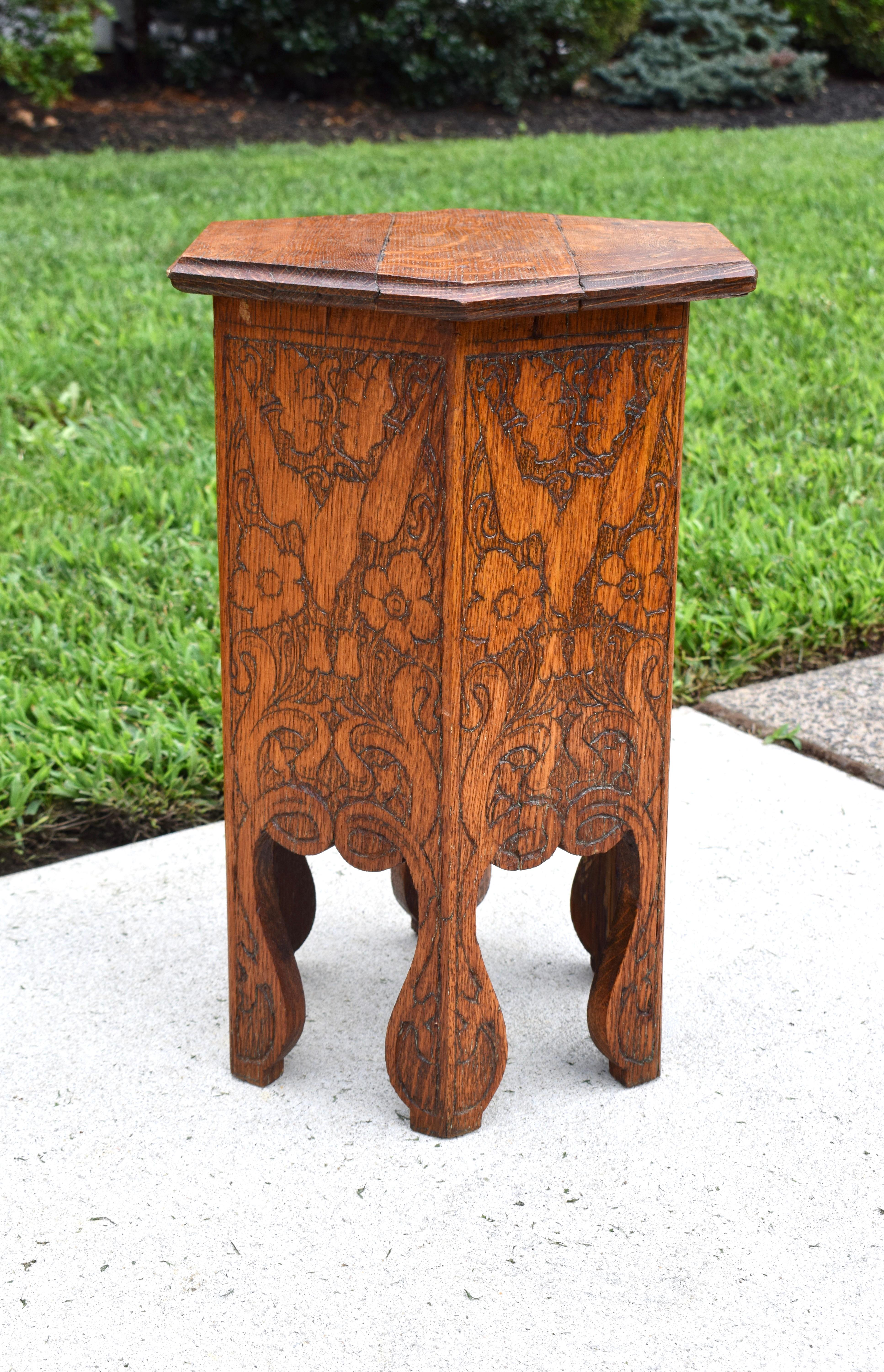 Turn of the 19th century studio made hexagon quarter sawn oak side table or stool with ornamental Swallow & floral hand carved details.  The Art Nouveau movement was inspired by the Aestheticism movement and by the British Arts and Crafts Movement. 