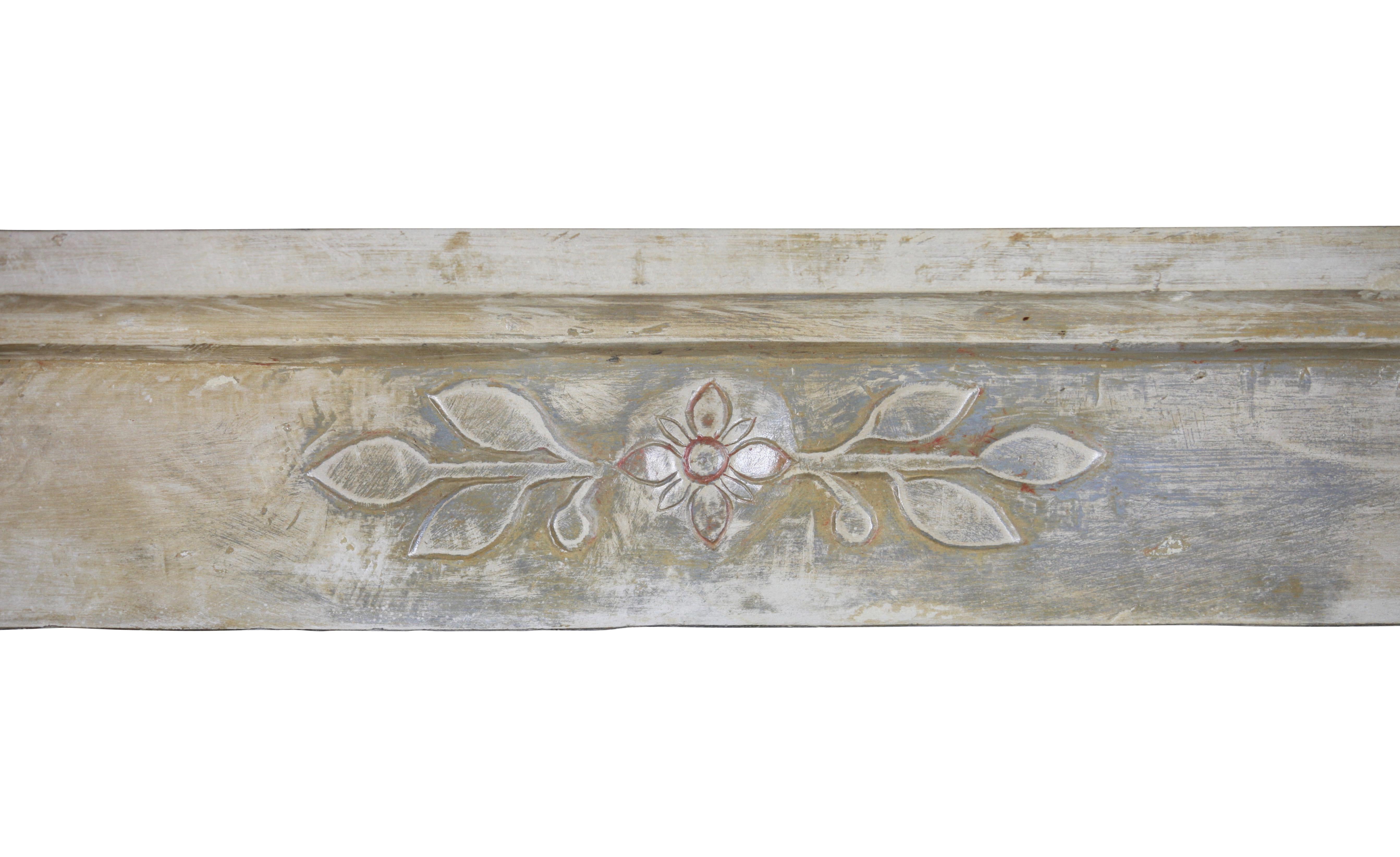 This is a original Art Nouveau French mantel in limestone. It has a silky touch and reflects the light in the room. This fine European antique fireplace surround carries a nice patina. Many people mix the Art Deco and the Art Nouveau. It has quite a