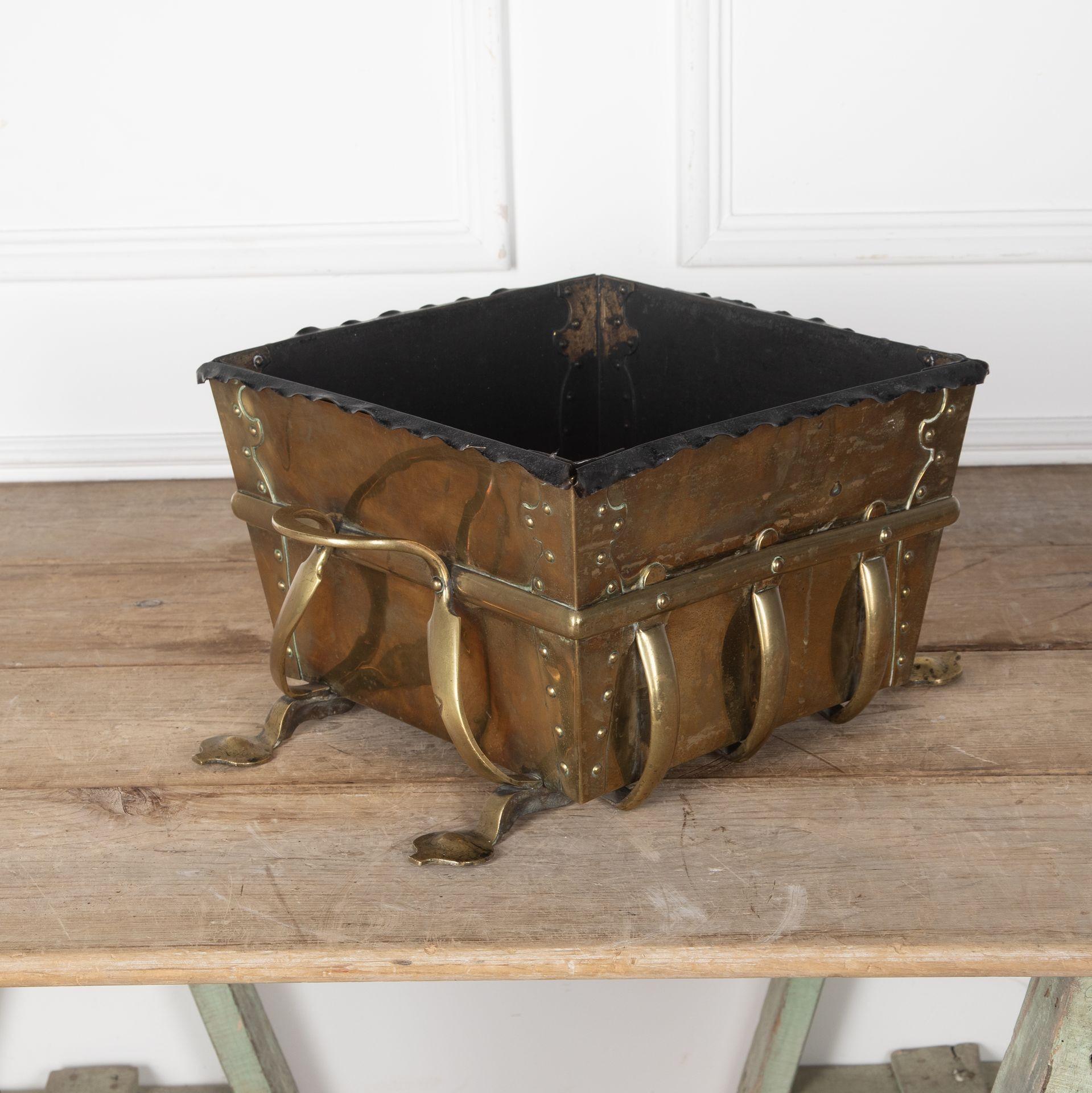 19th Century large rectangular brass Art Nouveau planter with strap handles.
Pad feet and original metal liner.