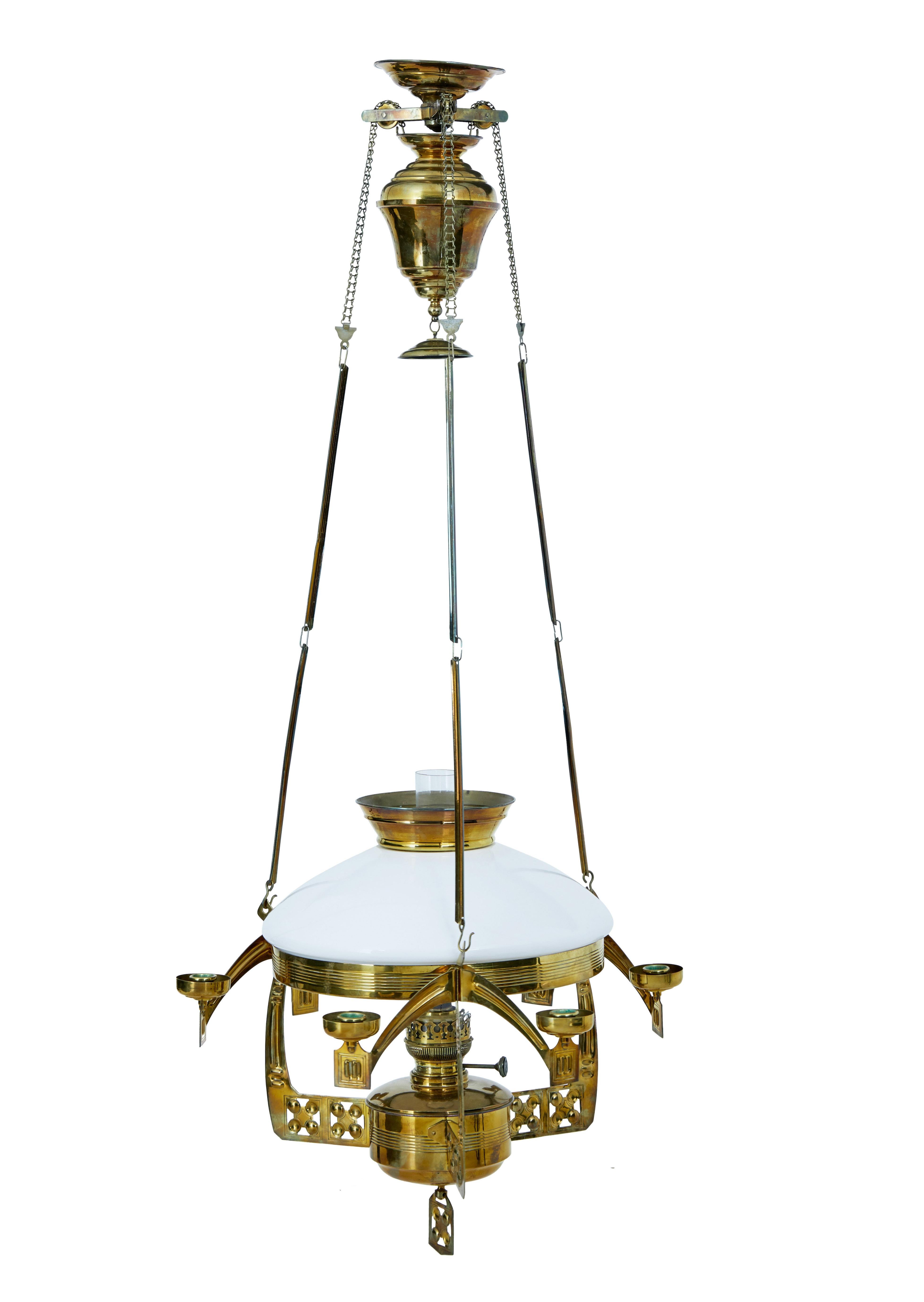 Fine quality arts and crafts rise and fall hanging oil lamp.

Strong in the arts and crafts design, all original parts present.  3 arm main body, each with a pair of additional candle holders.

White opaline glass bowl.  Suspended by 3 links to the