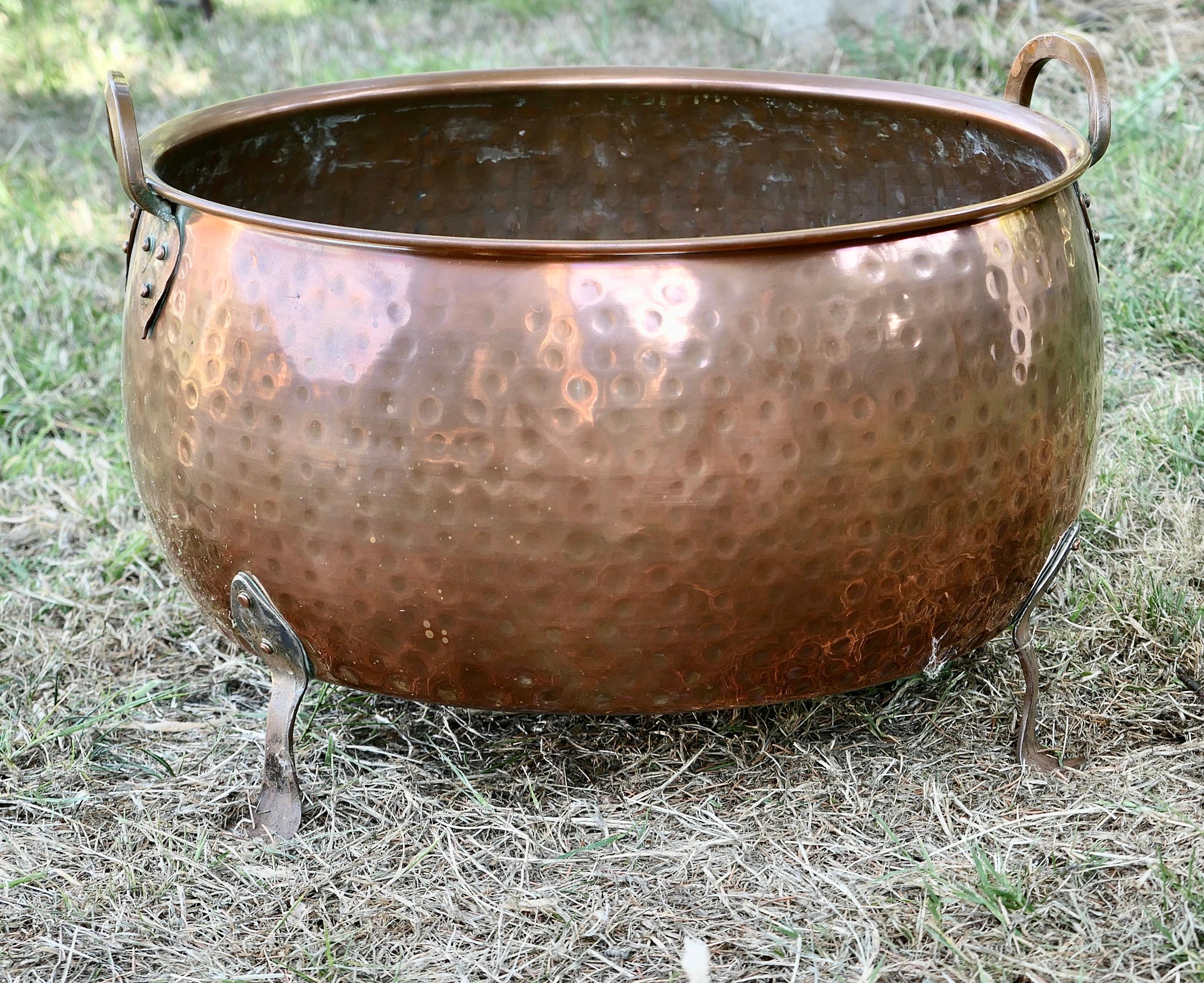 19th Century Arts & Crafts copper log bin or planter.

This is a good quality copper piece, it is made in hand beaten copper, with riveted copper handles and Iron feet 
The Bowl would work well as a log basket or as a planter for a large