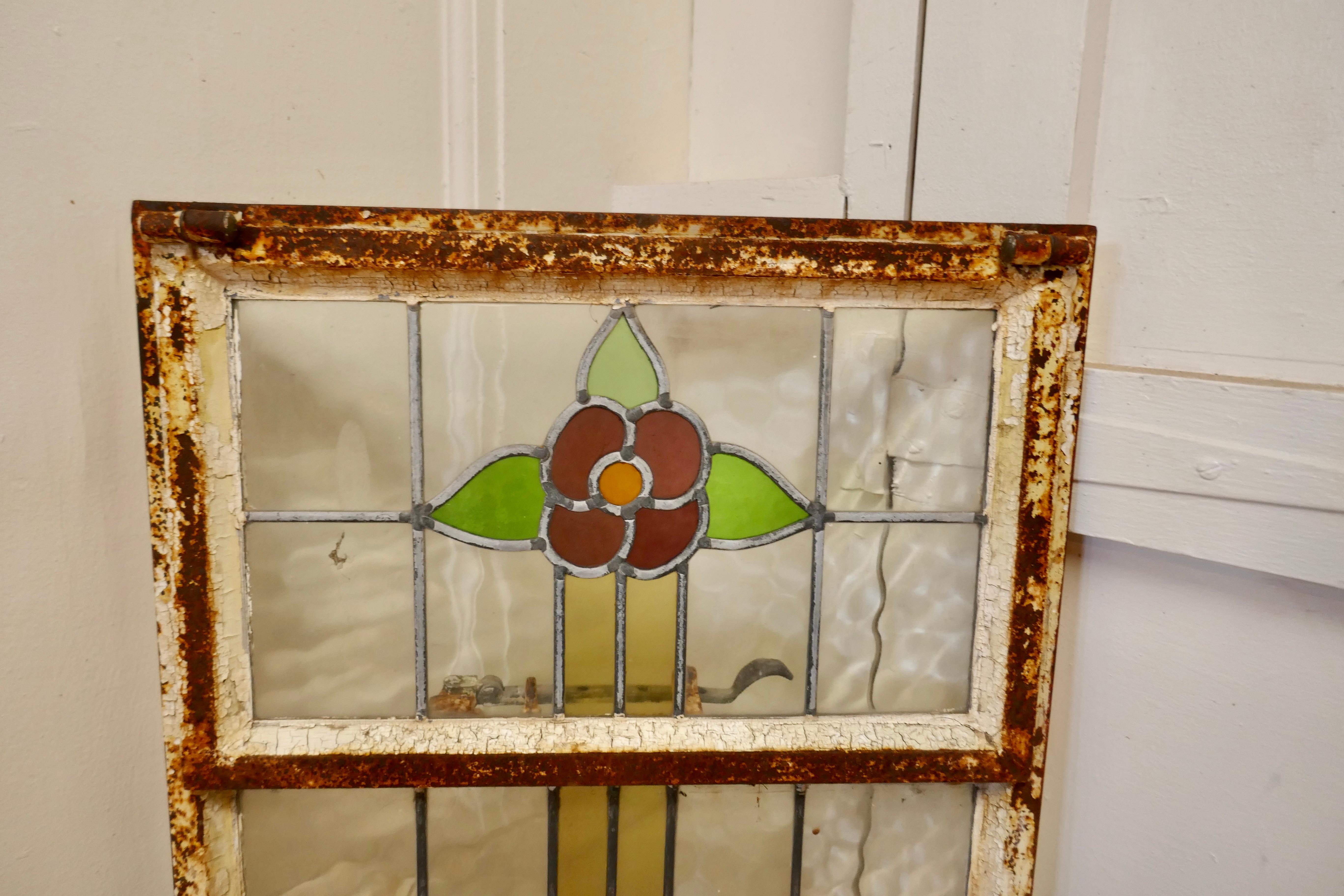 19th Century Arts and Crafts Stained Glass Window 

This is a pretty and colourful Arts and Crafts Cast iron window, with stylised Flowers in stained glass,
The window is long with the top section openable, the glass is in good condition the iron