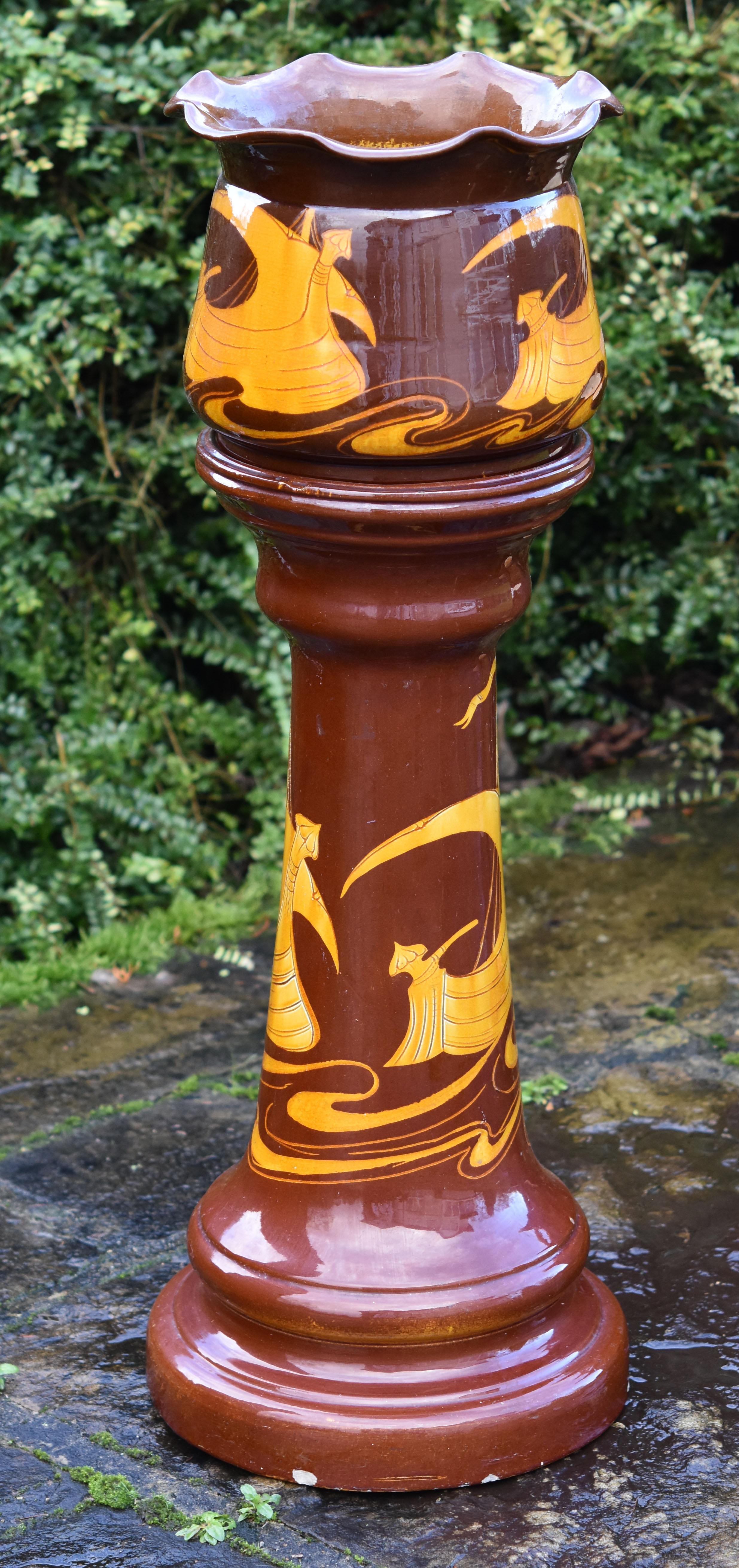 A very rare and excellent quality 19th century Arts & Crafts jardiniere on stand manufactured by the English company Bretby, circa 1890.
The flared top jardiniere and pedestal decorated in the scrafitto technique (carved decoration) depicting the