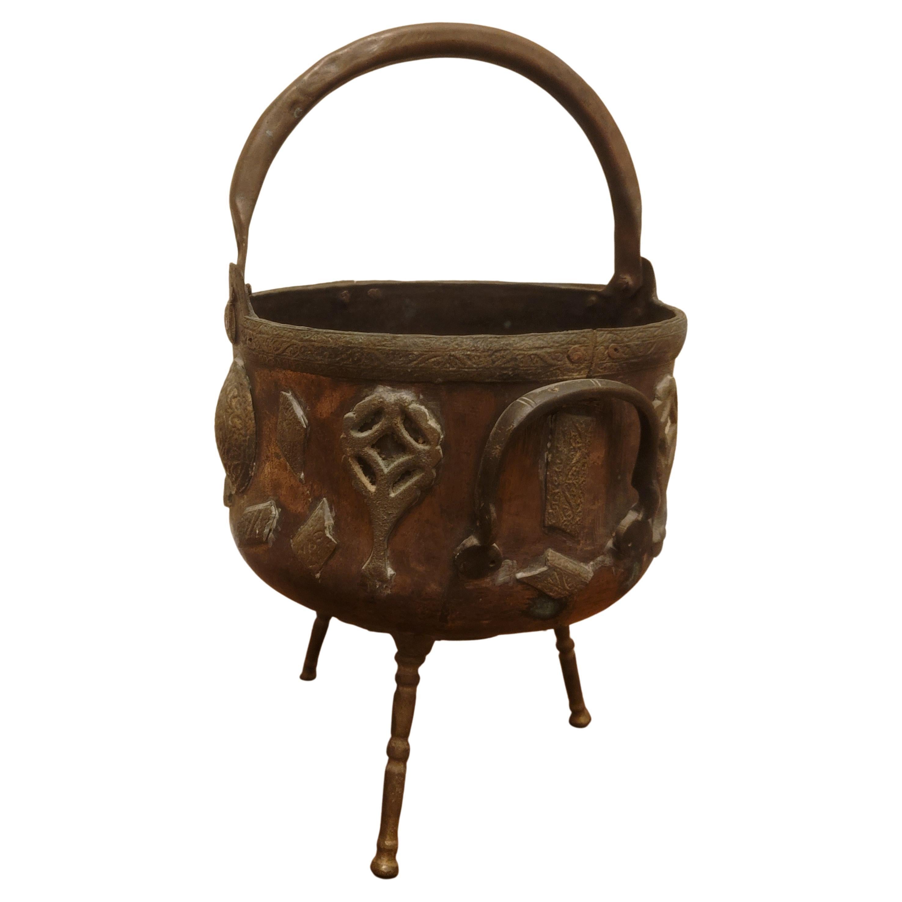 Highly decorative 19th century Arts & Crafts brass Mounted over Hammered Copper Footed Fireplace Pail bucket, with hammered copper handle. May be used as a log holder or as a planter. Measures 12 inches in diameter and stand 17 inches tall to the