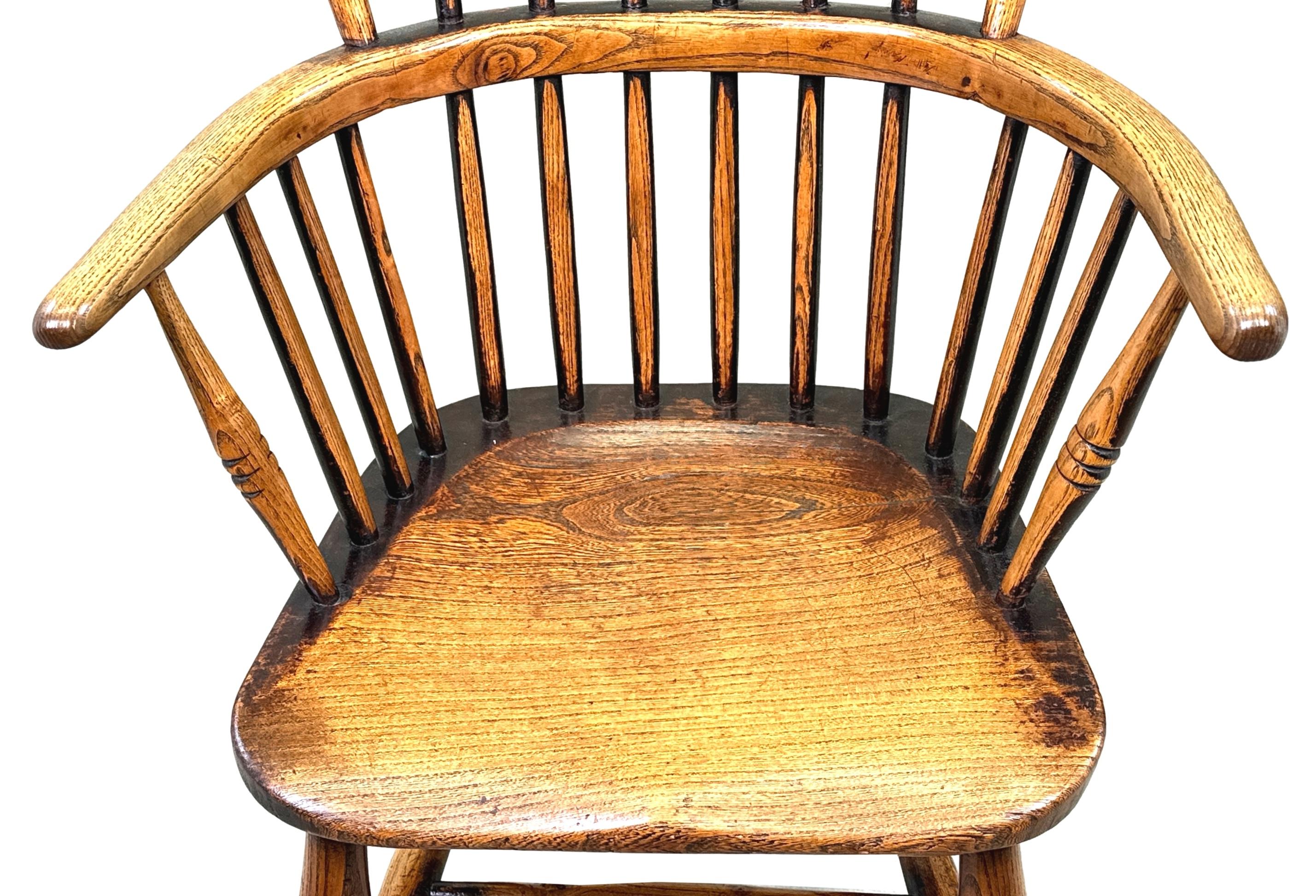 A Charming Mid 19th Century Childs Size, Ash And Elm Windsor Armchair Having Elegant Hooped Curved Back With Stick Turned Upright Supports Over Attractive Figured Seats, Raised On Elegant Turned Legs And H Stretcher, With Unusual Plain Turned Back