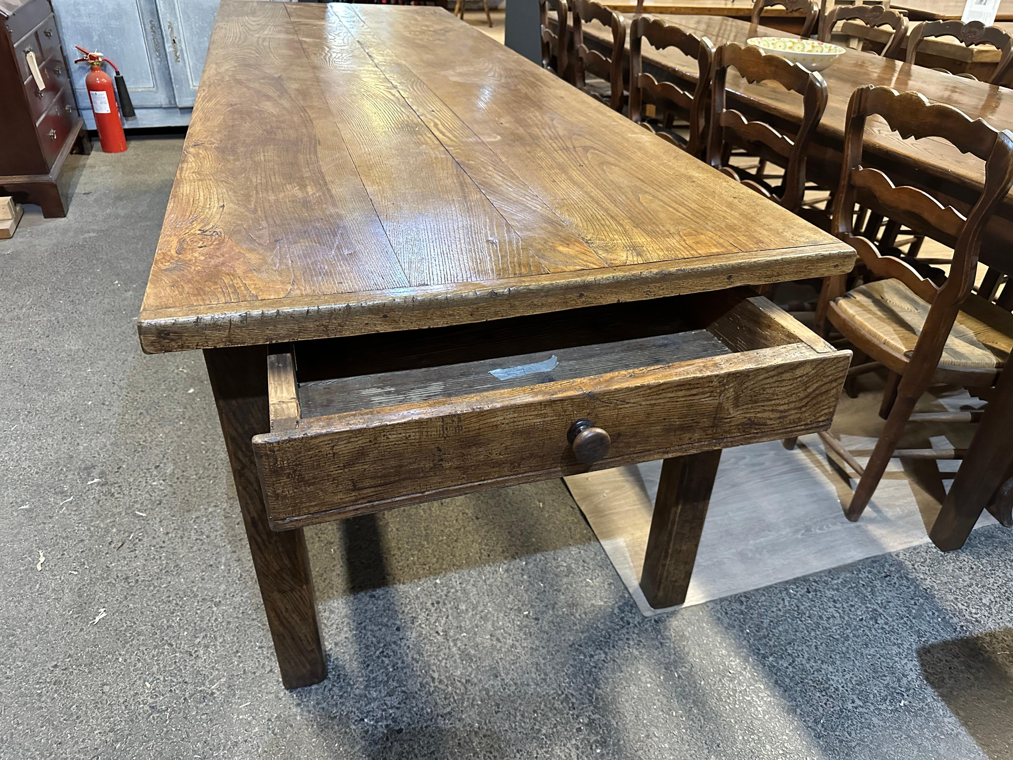 
19th Century Ash Farmhouse Table with one drawer. The table stands on a gorgeous base with four chamfered legs and lovely brackets on the ends. The four plank top has stunning patination and colour. 

The top, which is constructed from ash thick