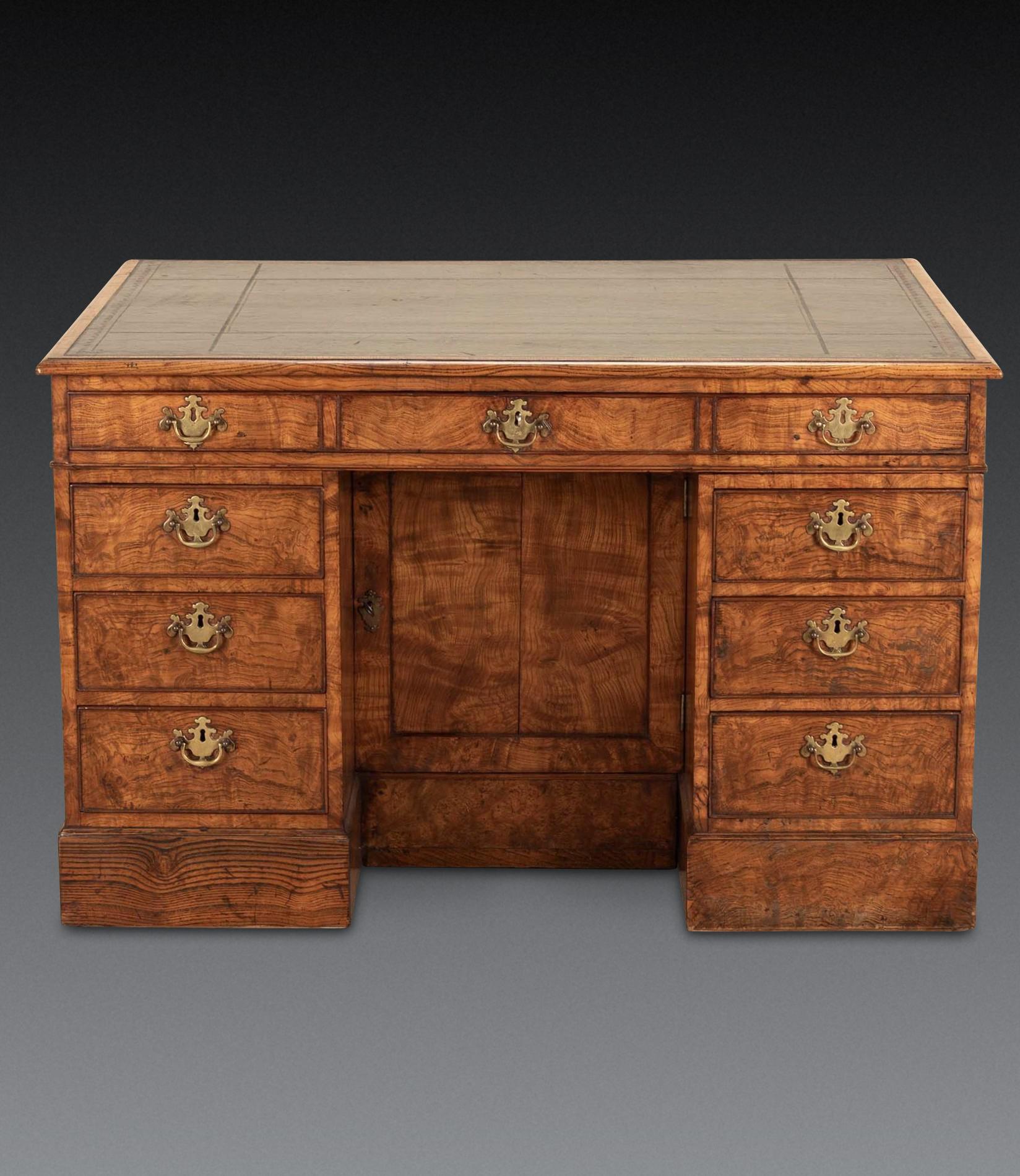 An unusual early C19th ash partners desk, with good quality green and gilt tooled leather top with moulded edge and having a useful feature of being able to extend its surface with the lift up flap to the reverse supported with two hinged lopers.