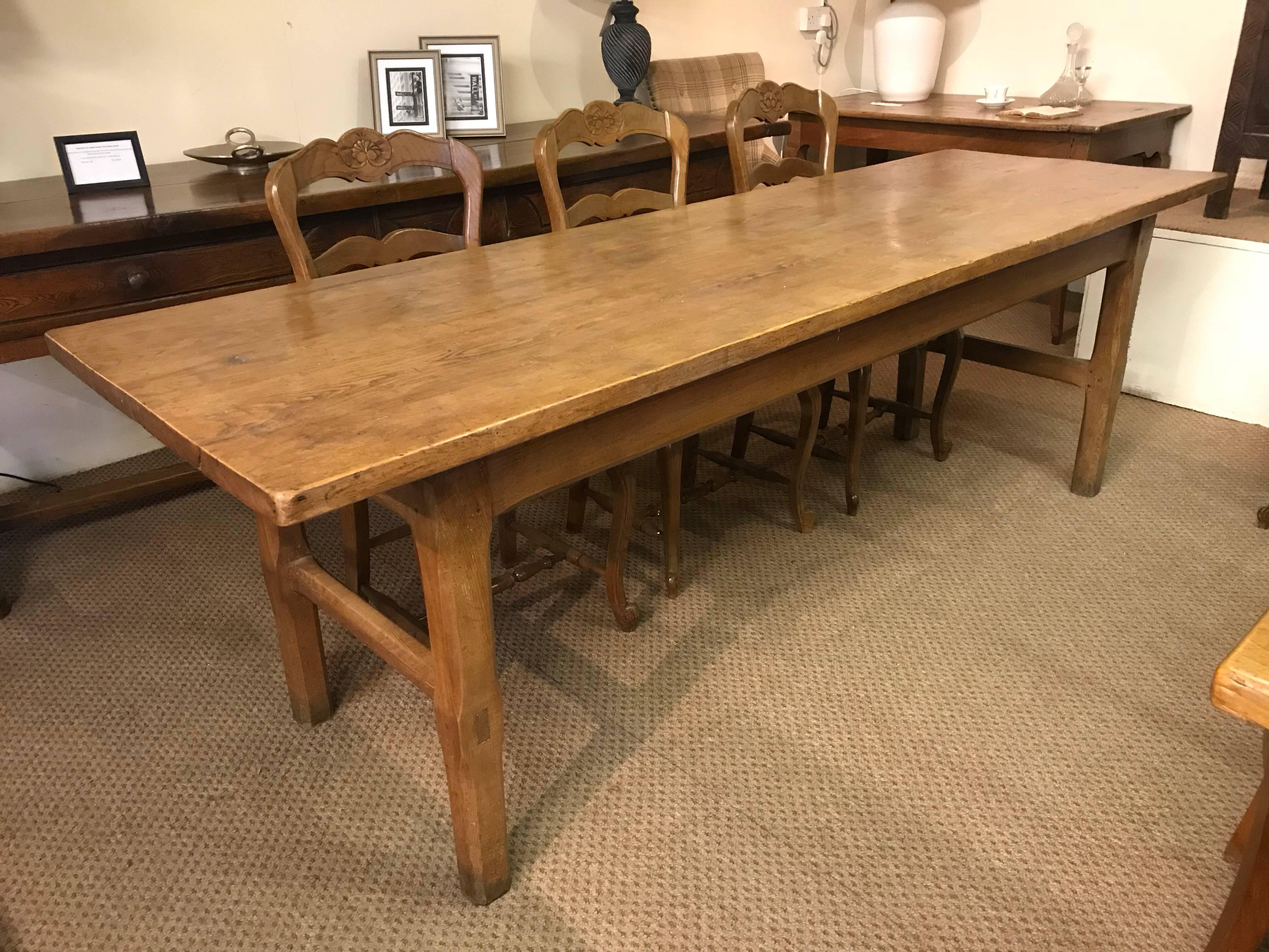 This ash pale French farmhouse table with a two plank top and sits on a sturdy frame with four square legs and end stretchers. Lovely color and patina. The table is circa 1840 and oozes character.