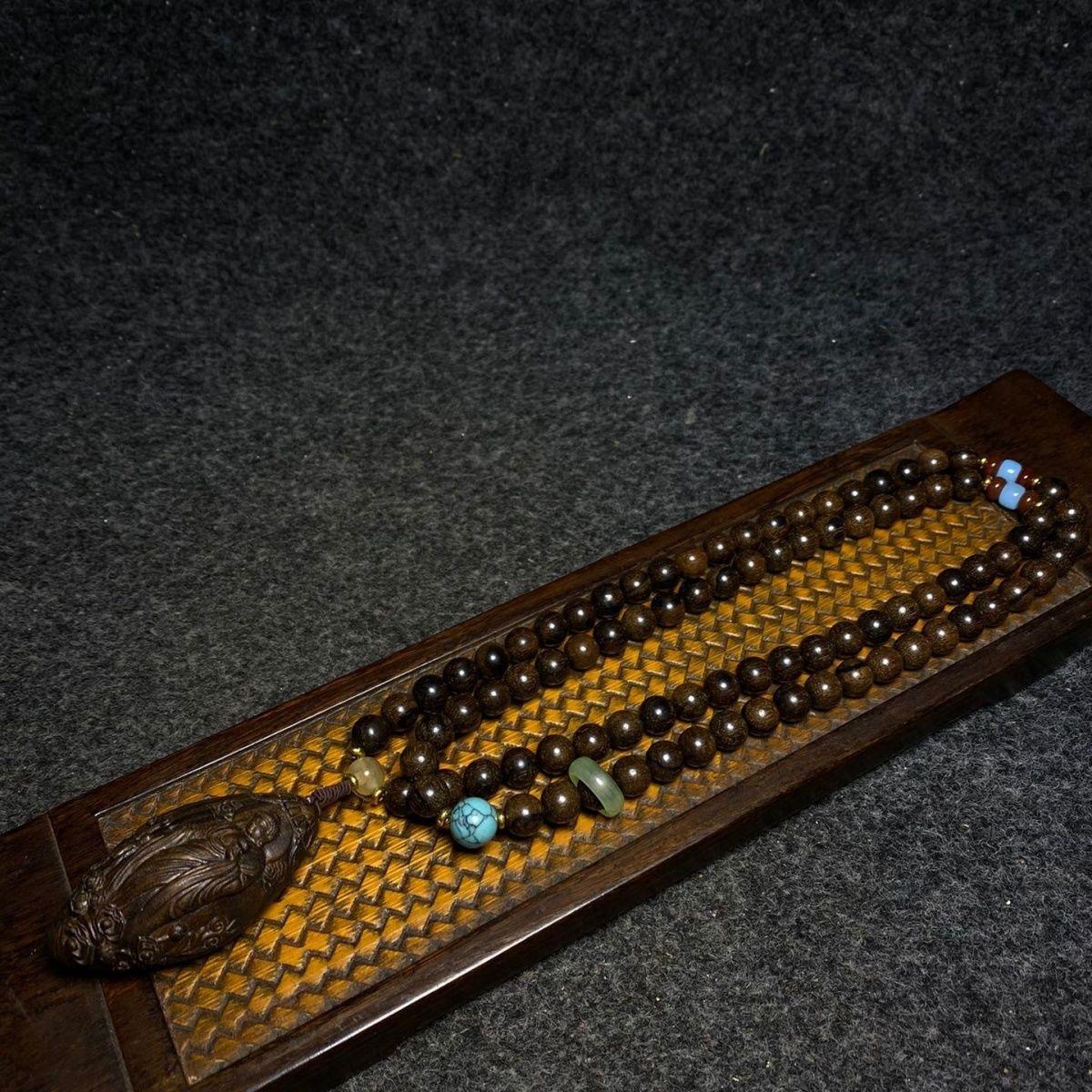 Immerse yourself in the spiritual and artistic heritage of Asia with this 19th Century Agarwood Necklace, featuring a meticulously hand-carved Buddha pendant and a string of 108 beads. Crafted from rare and fragrant agarwood, this necklace is both a