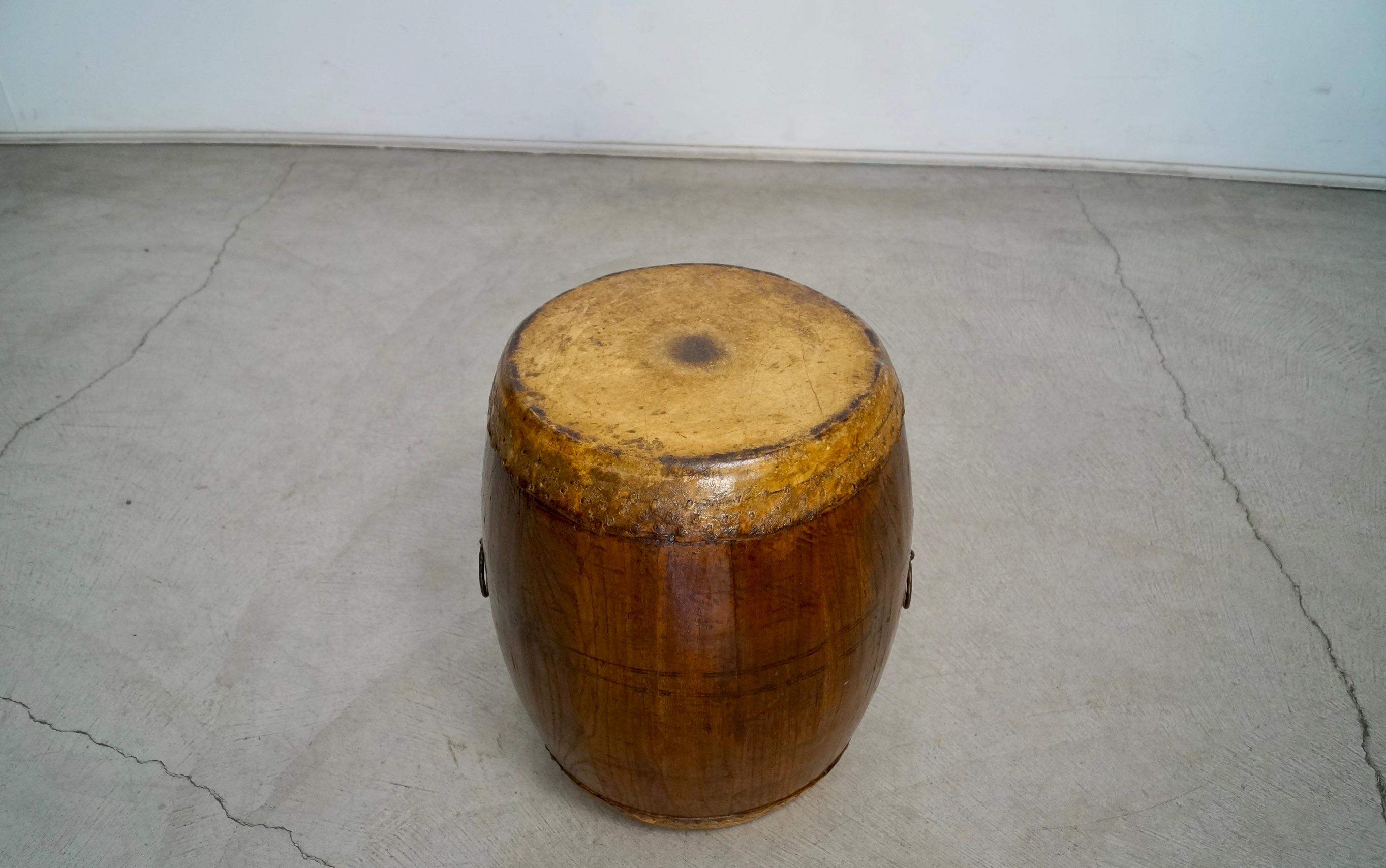 Beautiful antique drum for sale. From Asia, and well cared for. Has leather tops on both end, and still has the original rings on both ends. It's made of solid oak with a walnut finish. Shows beautiful patina throughout. Can be used as a side table,