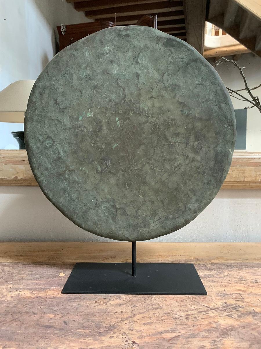 A probably Southeast Asian bronze gong dating from the 19th century. Lots of patina and beautiful color. As an object it has good presence and a universal shape.