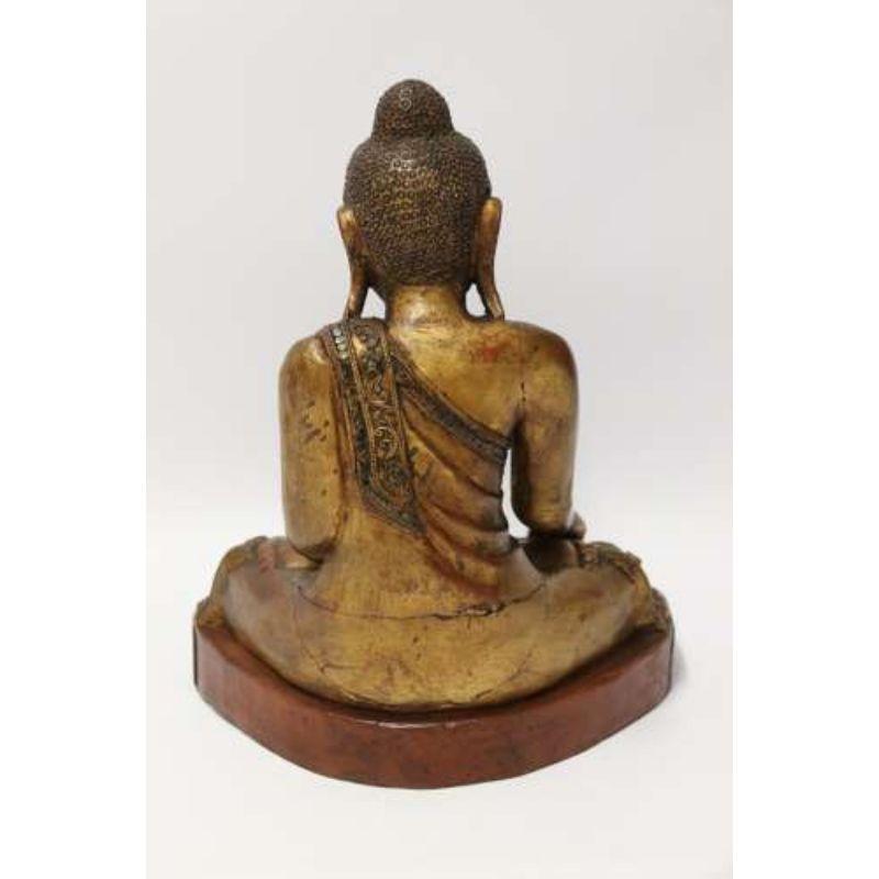 A 19th C Asian carved gilt wood Buddha

This highly decorative Burmese or Indian carved hardwood study of the seated Buddha has been well carved in hardwood. It is decorated with delicate tube lined gesso with multiple small coloured glass disks