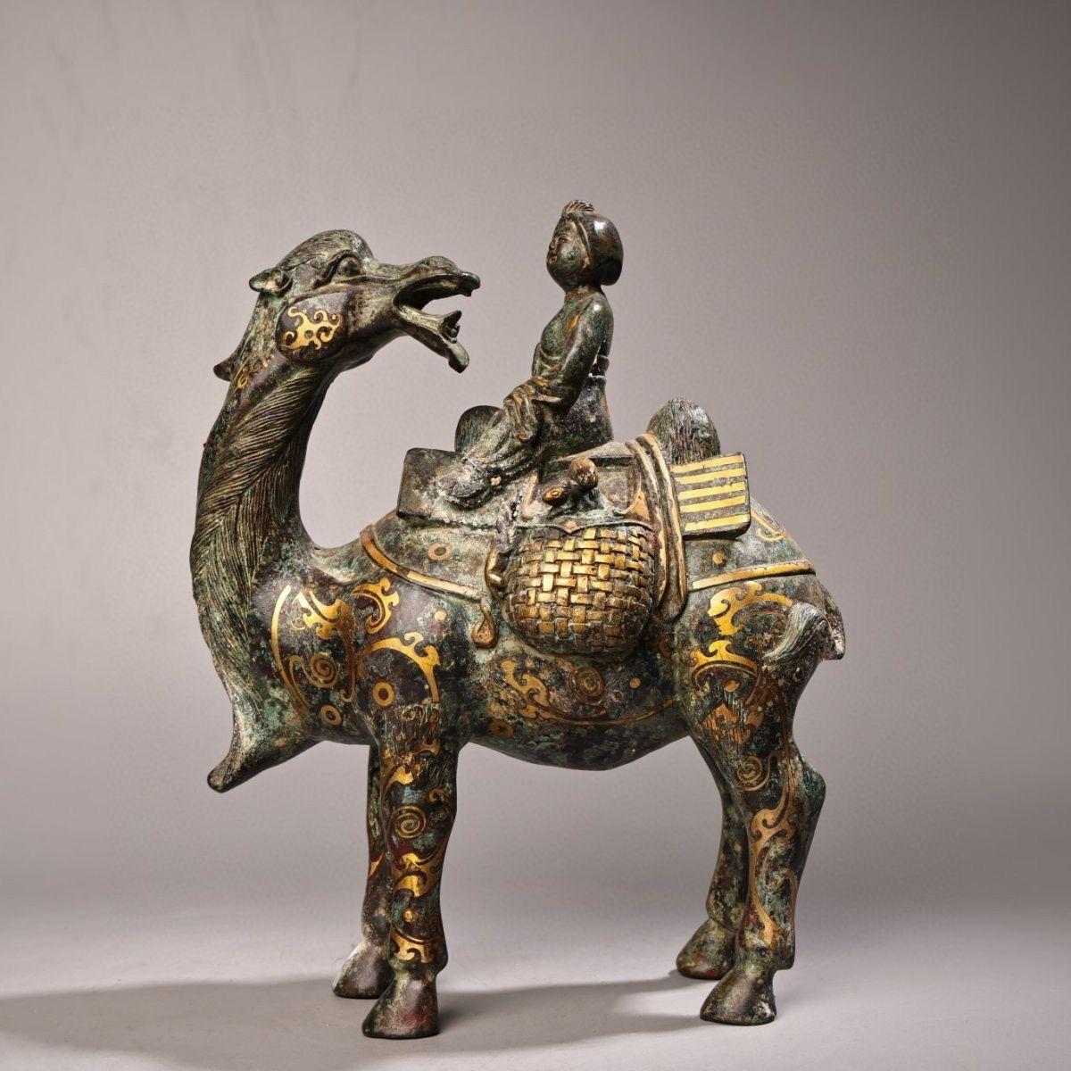 Elevate your collection with this 19th Century Asian Gold Bronze Statue featuring a finely detailed depiction of a lady gracefully riding a camel. This exquisite piece captures the cultural and artistic sophistication of the era, blending elegance