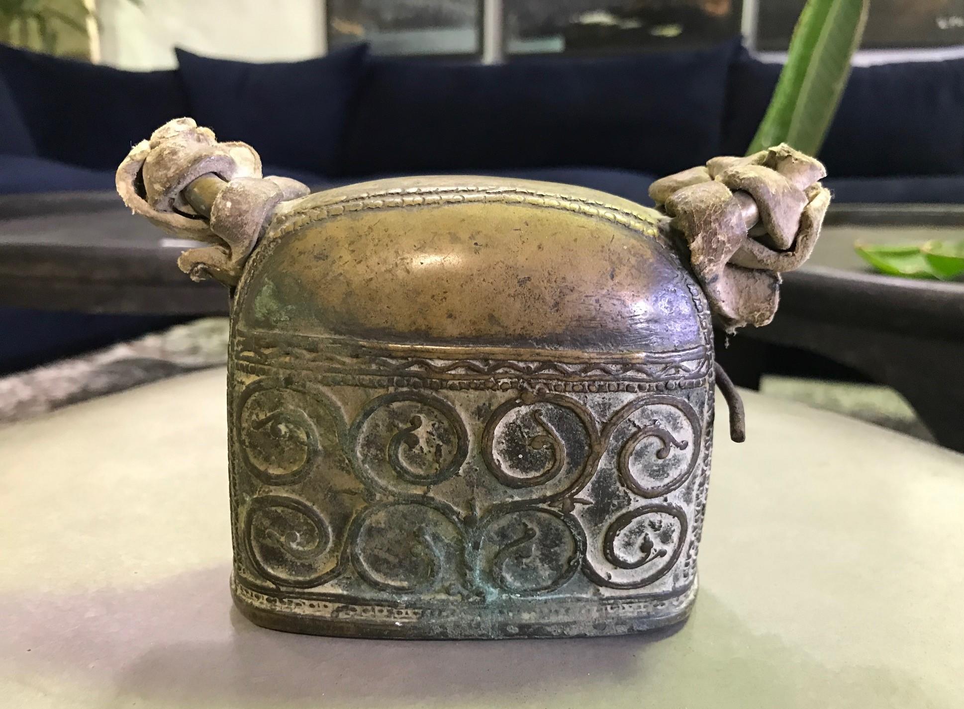 A fantastic Primitive piece. Hefty and well detailed with clear signs of age and use. Nice patina. Appears to have original leather straps. 

Likely from India or Southeast Asia. 

Sure to stand out accent piece in about any setting.