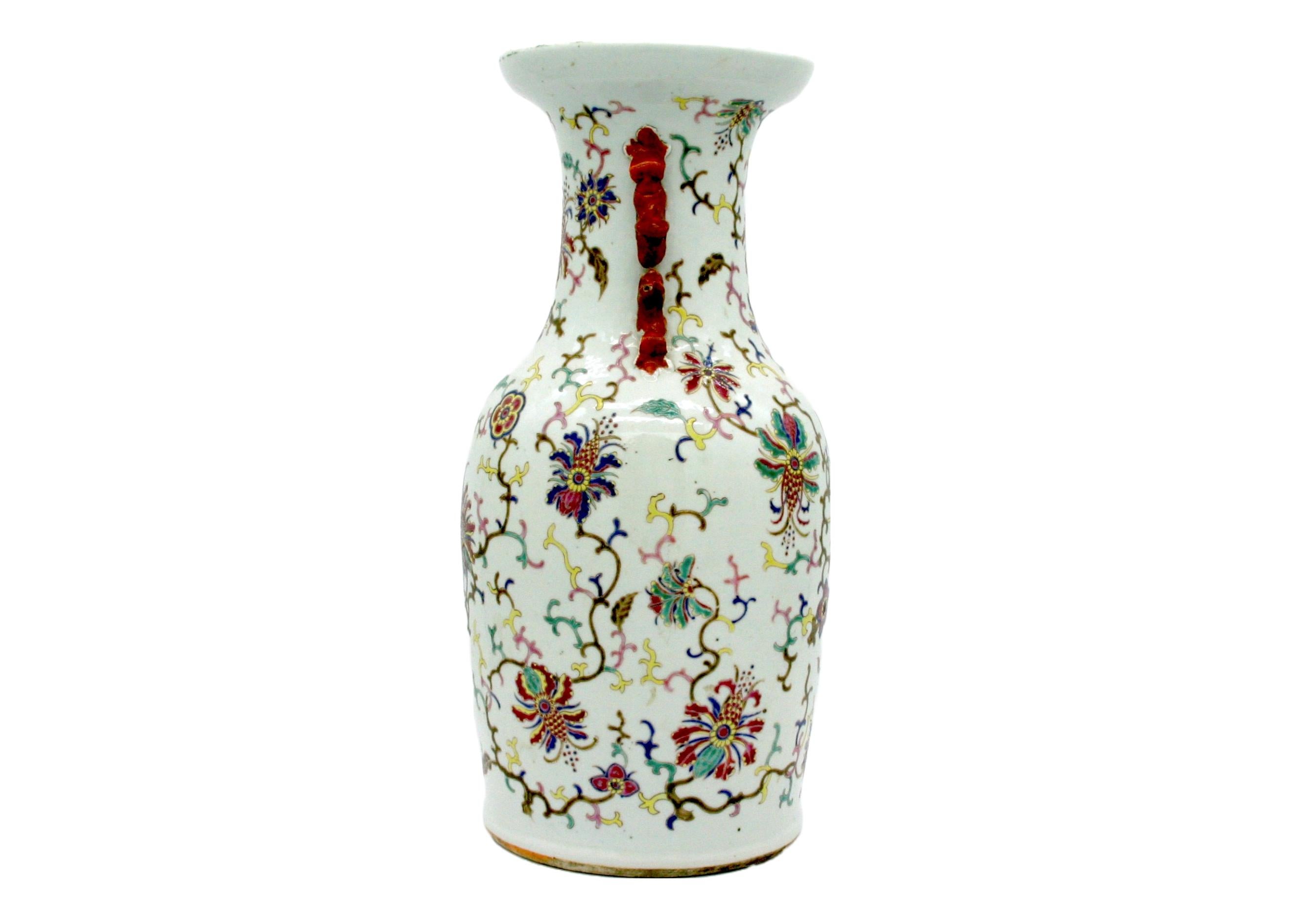 Late 19th century hand painted and crafted Chinese porcelain decorative urn / vase with exterior floral details and side handles. The vase is in great condition. Minor wear appropriate with age / use. The piece measures 17 inches tall X 8 inches