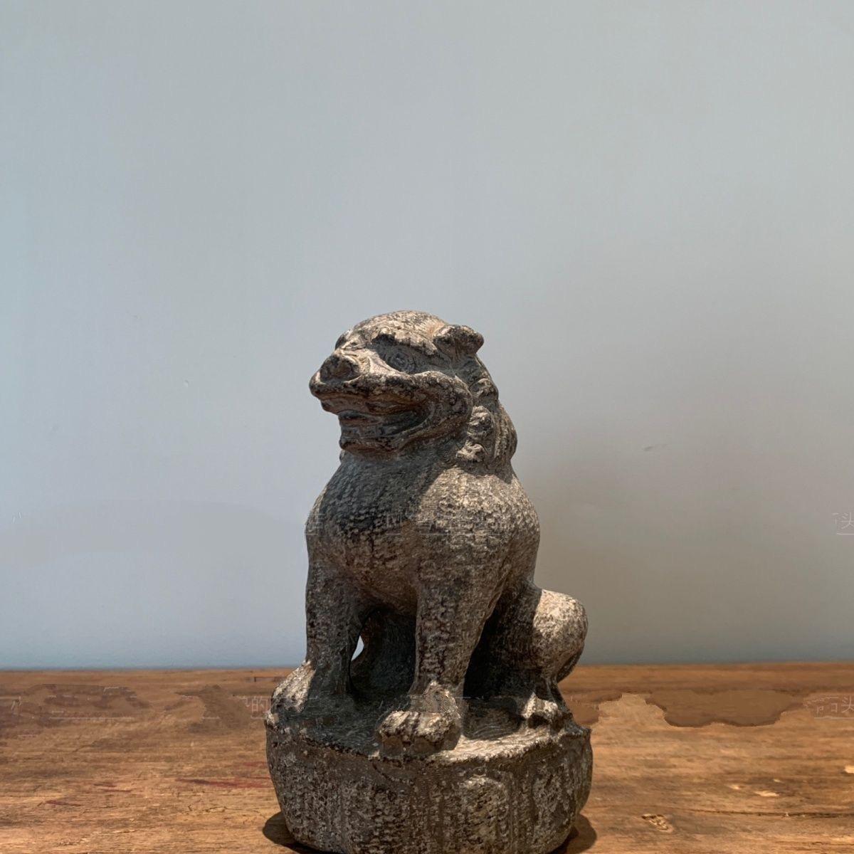 Add an air of strength and elegance to your collection with this 19th Century Asian Stone Hand-Carved Sitting Lion Statue. This finely crafted piece captures the majestic presence of a lion in a seated posture, symbolizing power, protection, and
