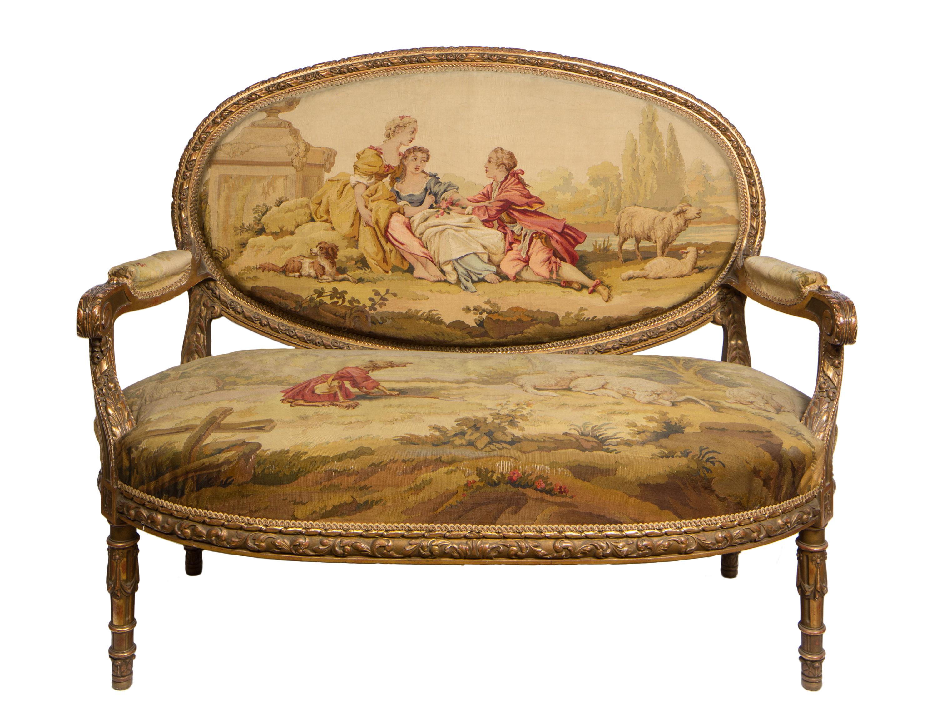 Upholstered in fine Aubusson tapestry fabric, this 19th century French Louis XVI style three-piece salon suite includes a settee and two matching armchairs.
The carved giltwood furniture nicely frames finely woven Aubusson tapestry upholstery