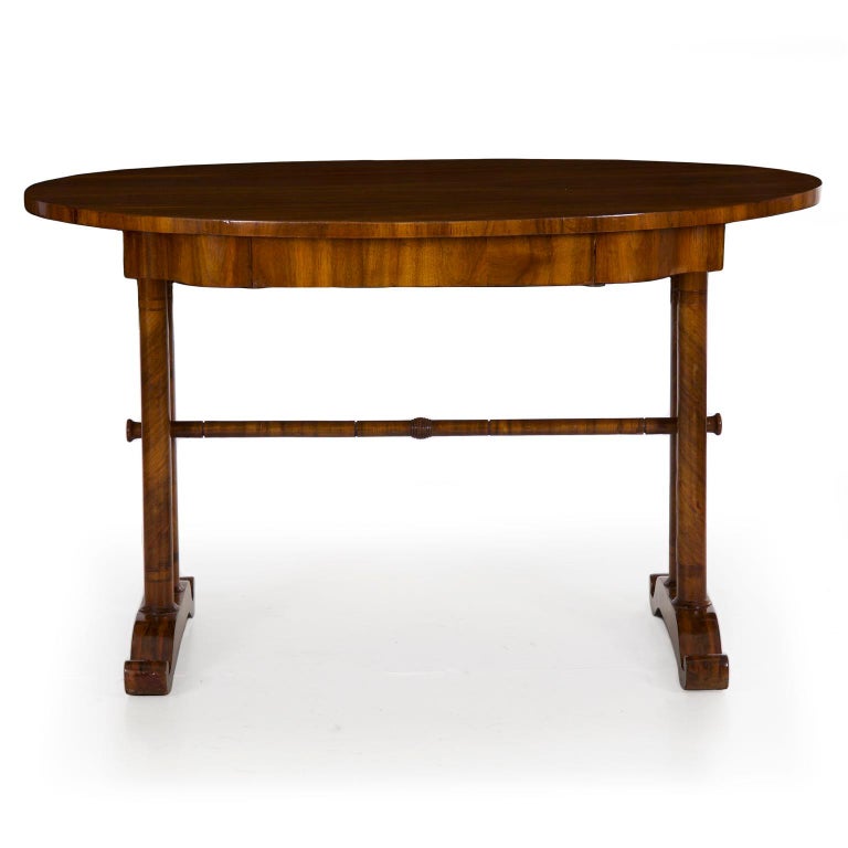 A fine austere writing table from the second quarter of the 19th century, likely Austrian or possibly German, the stand is distinctly neoclassical with its twin columns and cupid’s bow footing. The veneer work is excellent with a spiral wrap of