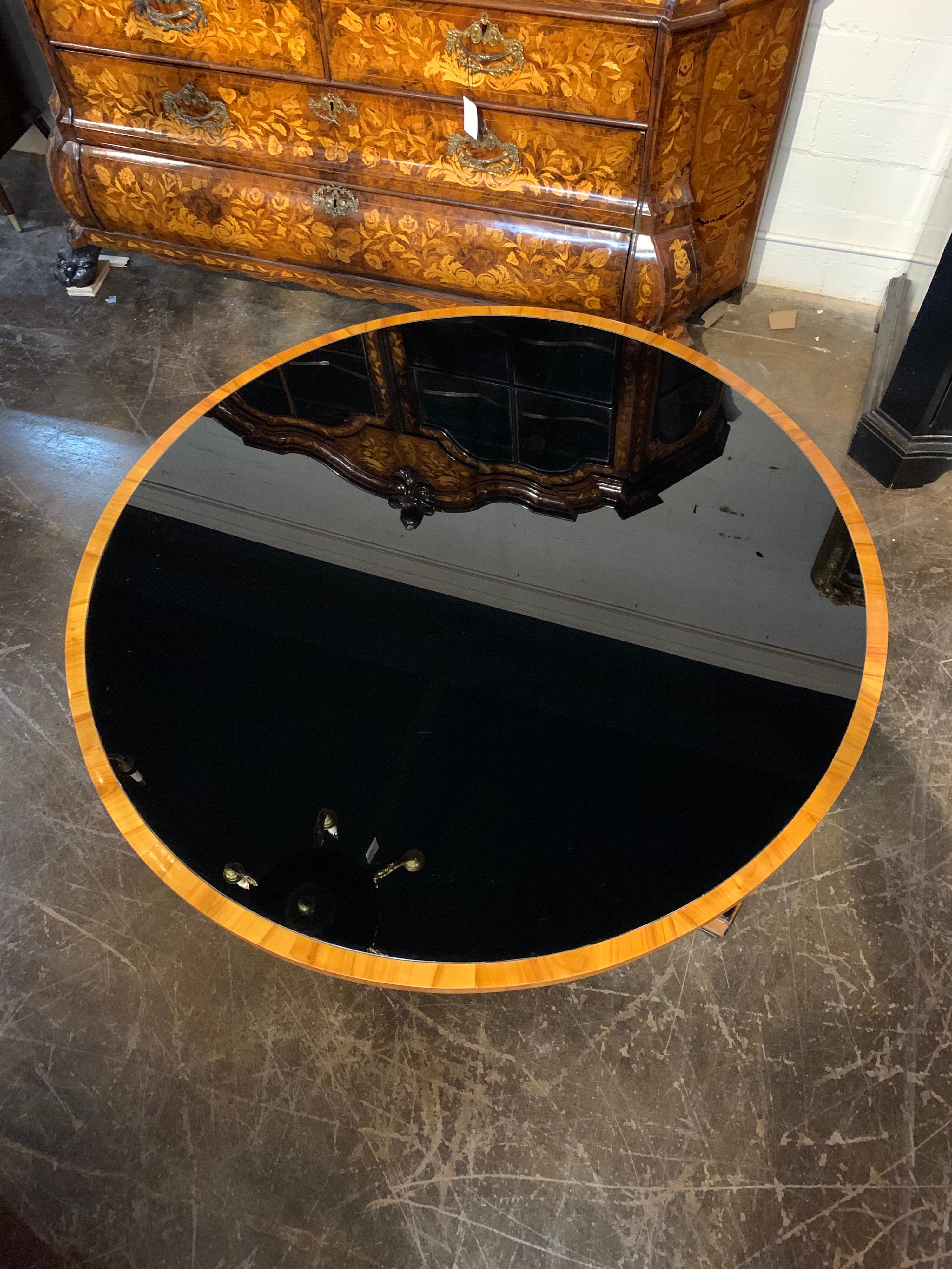 Elegant 19th century Austrian Biedermeier Empire style walnut center table with black glass top. Very fine finish on this piece and a classic style!