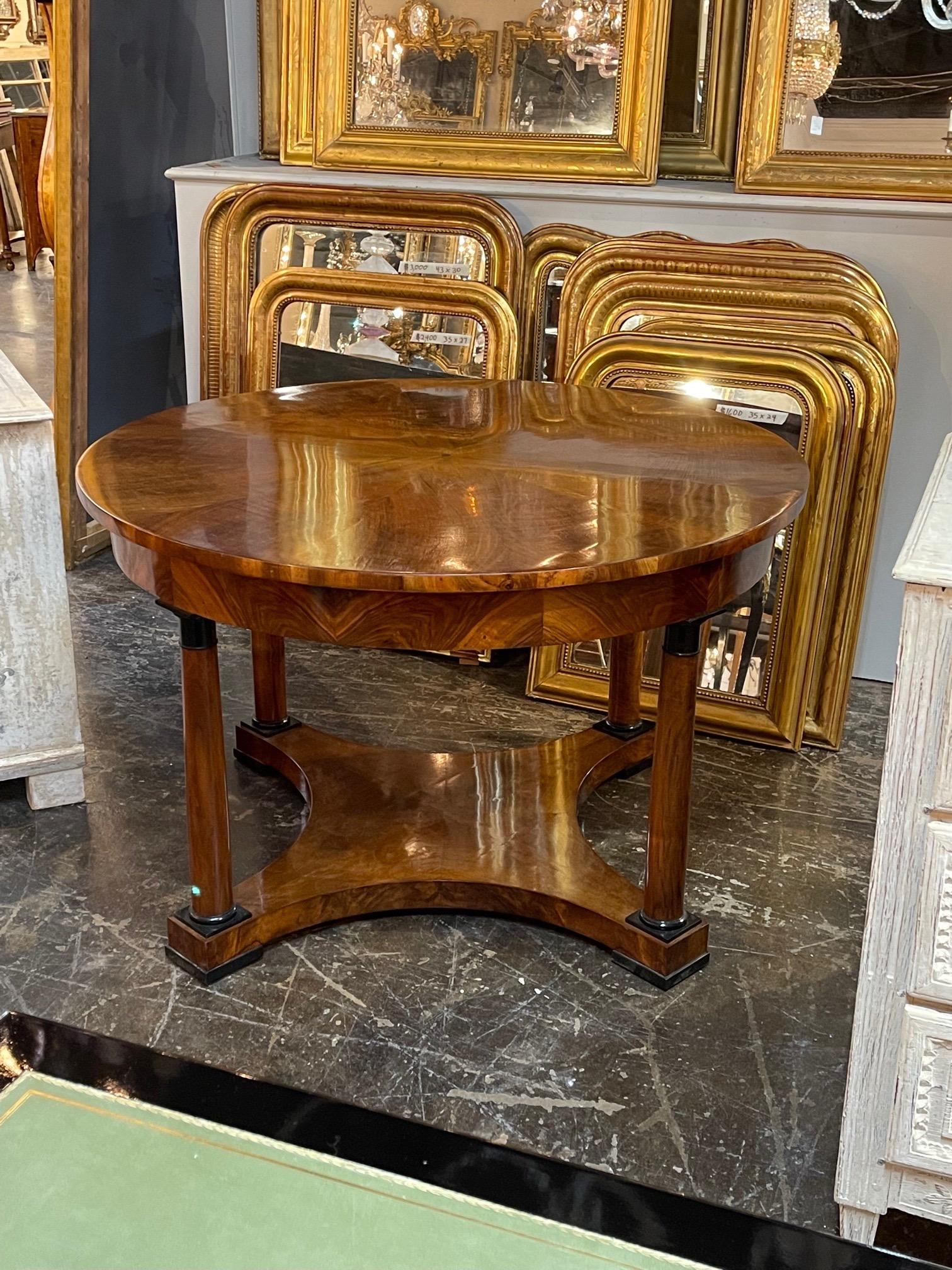 Very fine 19th century Austrian Biedermeier Empire style walnut center table with ebonized details. Gorgeous finish on this piece and a subtle pattern on the top. An exceptional table!!