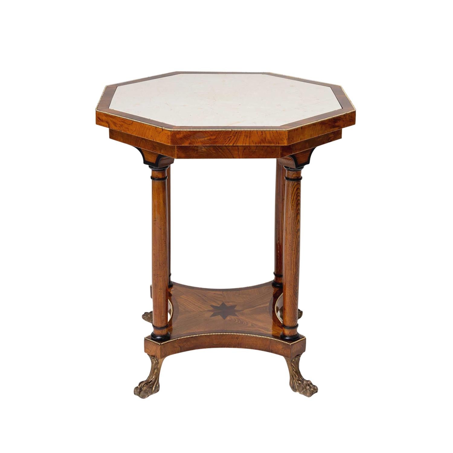 An octagonal, occasional antique Austrian Biedermeier side table made of hand crafted shellac polished, partly veneered Ashwood, in good condition. The top of the petite end table is composed with a white stone plate, particularized by brass