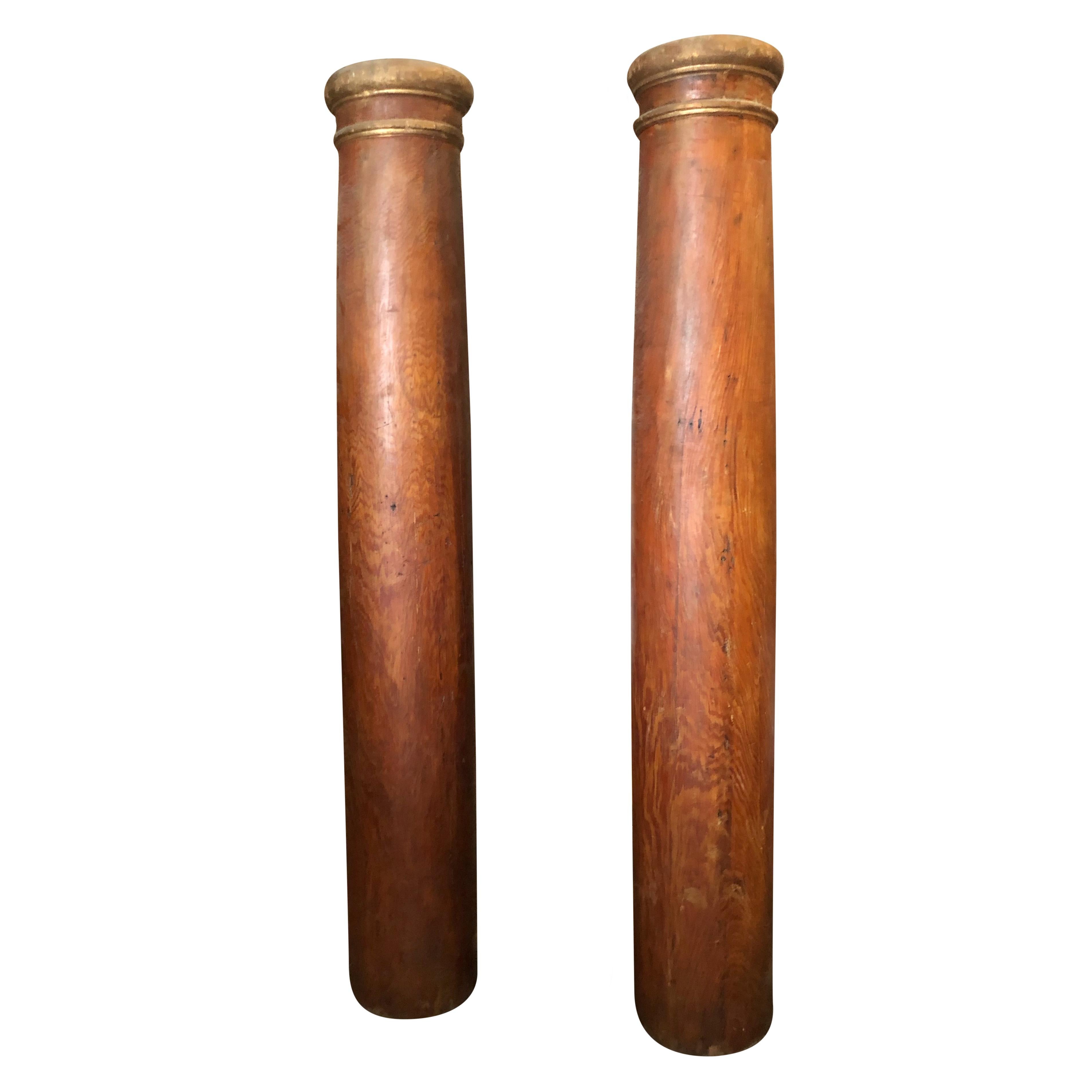 An antique Austrian Biedermeier pair of columns made of hand crafted polished Cherrywood, in good condition. The tall to décor pieces are enhanced by gilded circles around the top. The Biedermeier period refers to a time period around 1815 - 1848 in