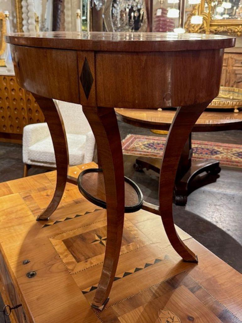This 19th century Austrian Biedermeier walnut and ebony side table exudes elegance and craftsmanship. This piece  features the use of luxurious materials such as walnut and ebony, showcasing the intricate craftsmanship of the era. Perfect for adding