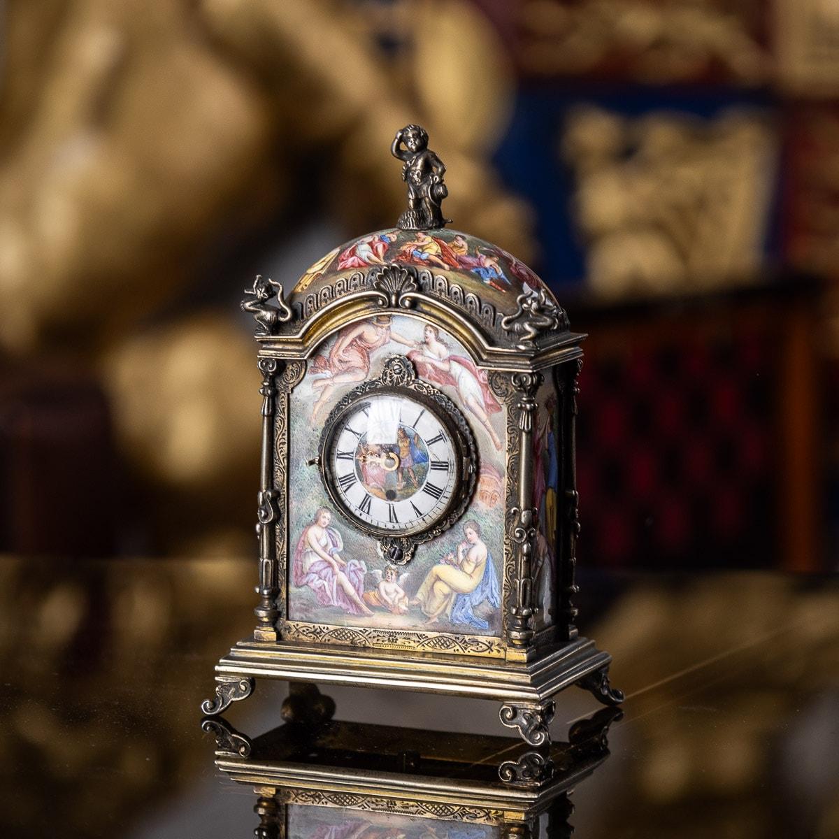 Antique late-19th century Austrian exceptional solid silver & hand painted enamel miniature clock, of traditional upright form, the corners set with columns, canopy mounted with figural finials. The front, sides and back hand painted with