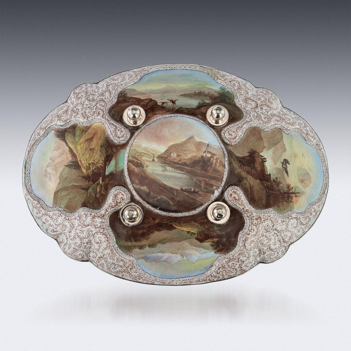 Antique 19th century Austrian hand-painted enamel dish applied with silver mounts. The scallop-shaped dish with a saucer centred with five reserves depicting various religious scenes, surrounded by scrolling foliage, masks and raised on four ball
