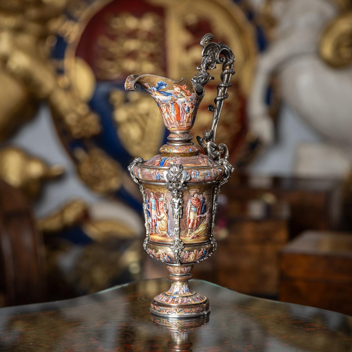 Antique late-19th Century Austrian exceptional solid silver & enamel ewer, standing on a raised round base, urn shaped, elaborate scrolled spout and the body hand painted throughout with classical allegorical scenes, applied with cast decorative