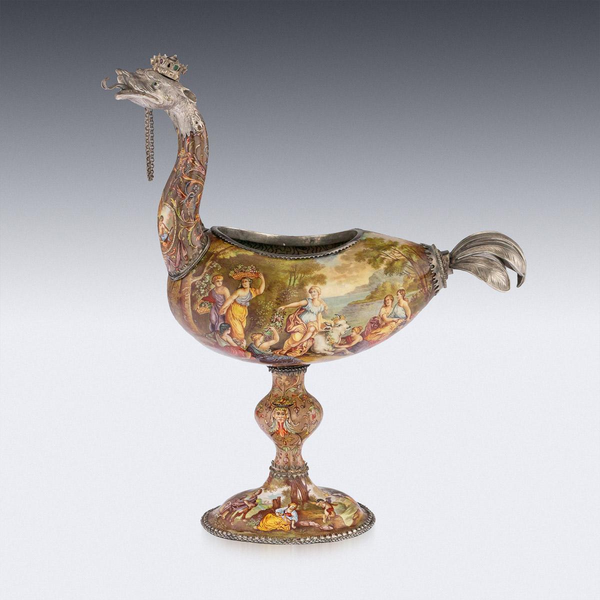 Antique late 19th century Austrian exceptional solid silver, enamel and gem set two-headed cup, standing on an oval base, shaped bulbous stem and the body hand painted with classical allegorical scenes, the mythical ostrich heads surmounted by