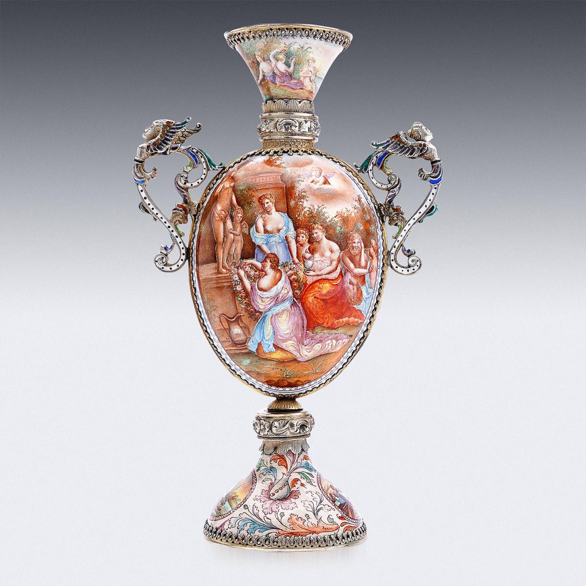 Antique 19th Century Austrian Renaissance revival solid silver enameled vase, the body supported by domed foot, beautifully enamelled with a multicolored foliage decoration around oval reserves dipicting various romatic scenes, the main body of the