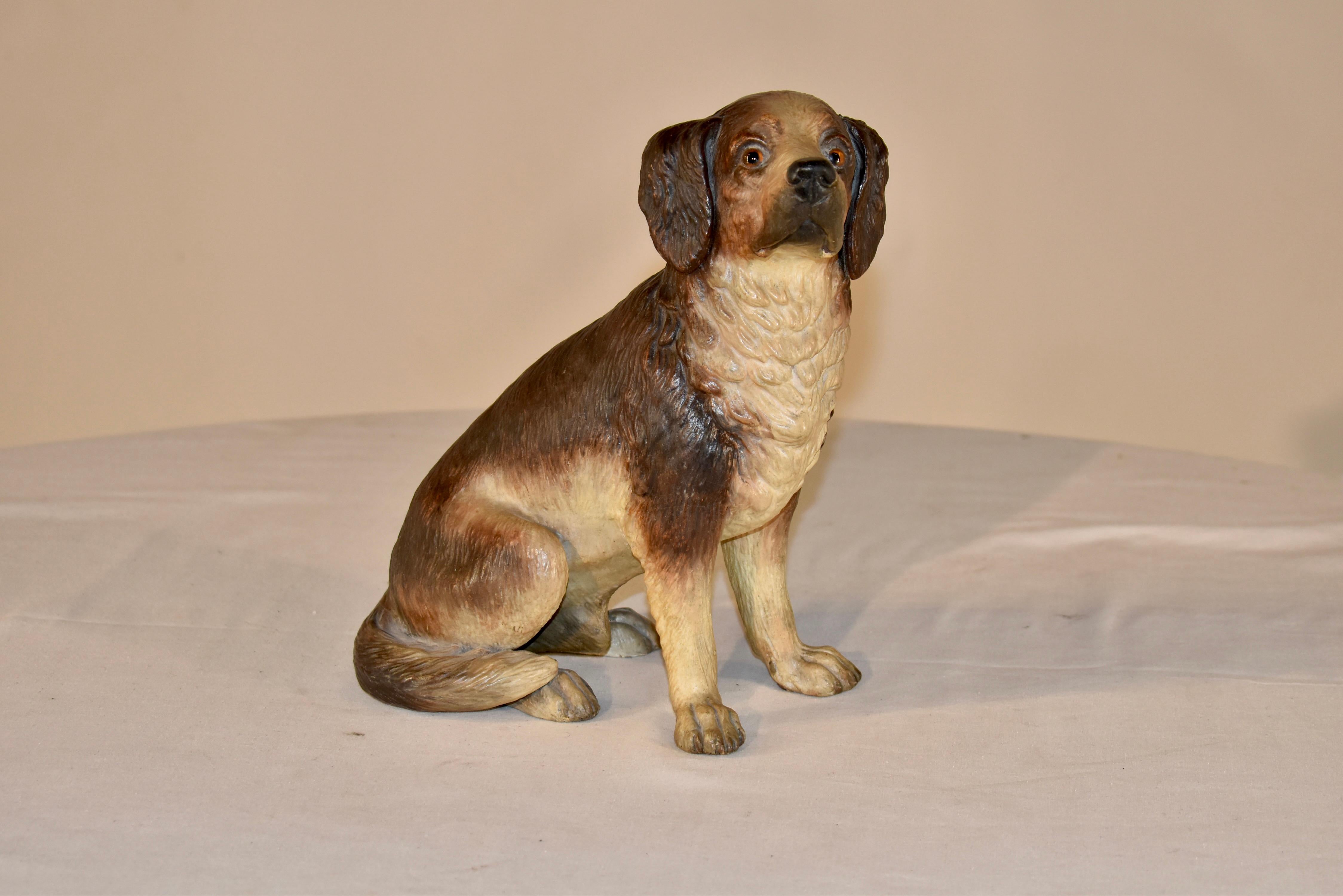 An exceptionally detailed 19th century painted terracotta dog from Austria. In a sitting position, it is hand painted with the original glass eyes. It is particularly expressive and detailed. In wonderful condition with no repairs or damage.