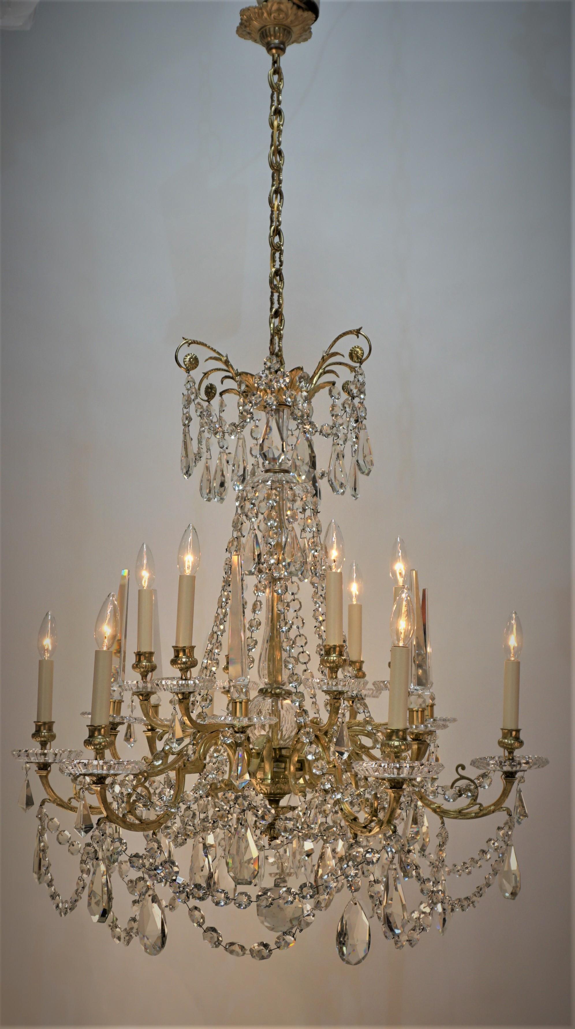 Elegant twelve light multi-faceted cut crystal and bronze frame chandelier.
Marked Baccarat.
Measurement: width 32
