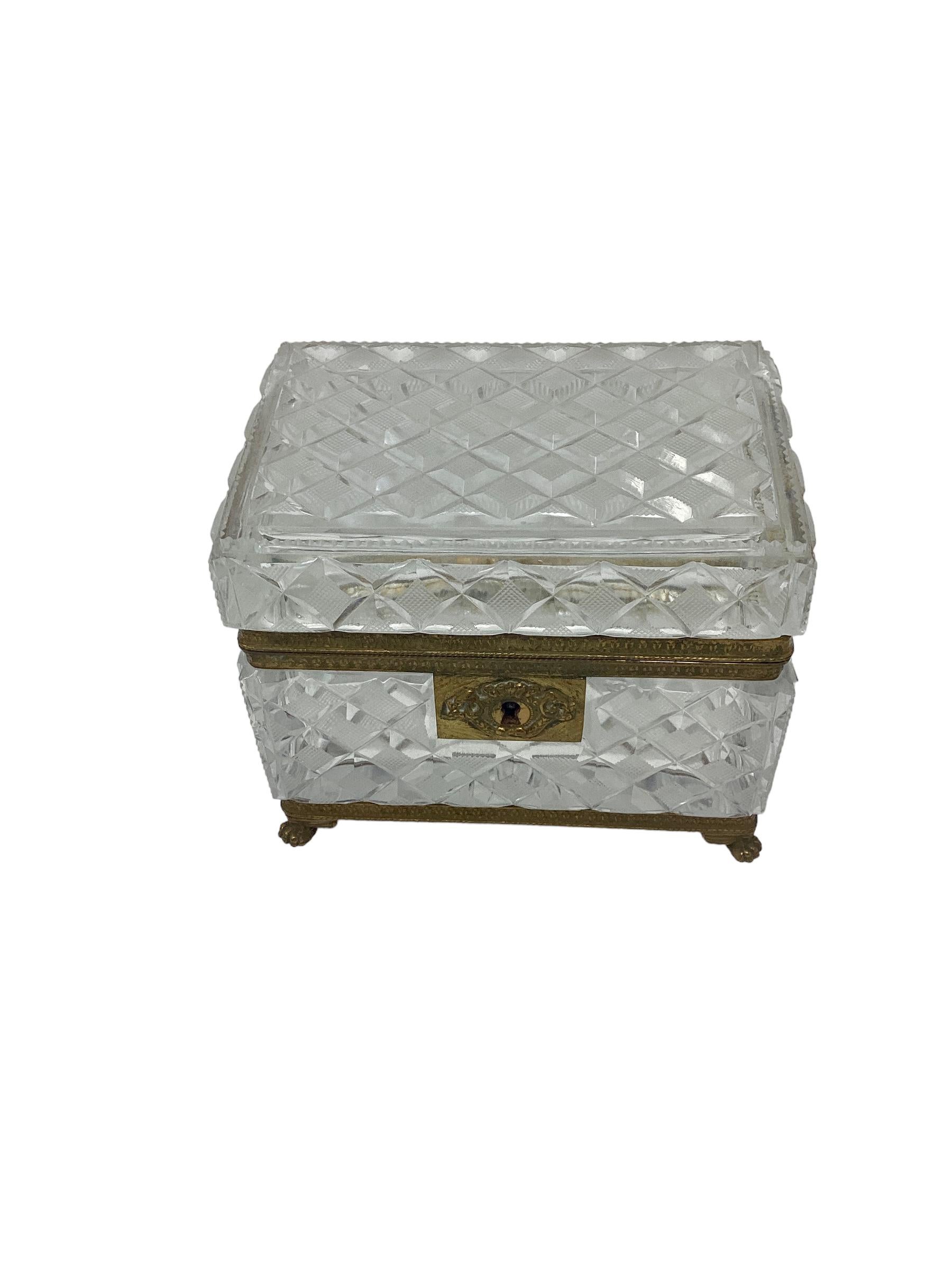 19th Century Baccarat Cut Crystal Box or Casket with Gilt Bronze Mounts. Beautiful cut crystal box in a faceted design. Box is mounted in a gilt bronze frame with paw feet.
