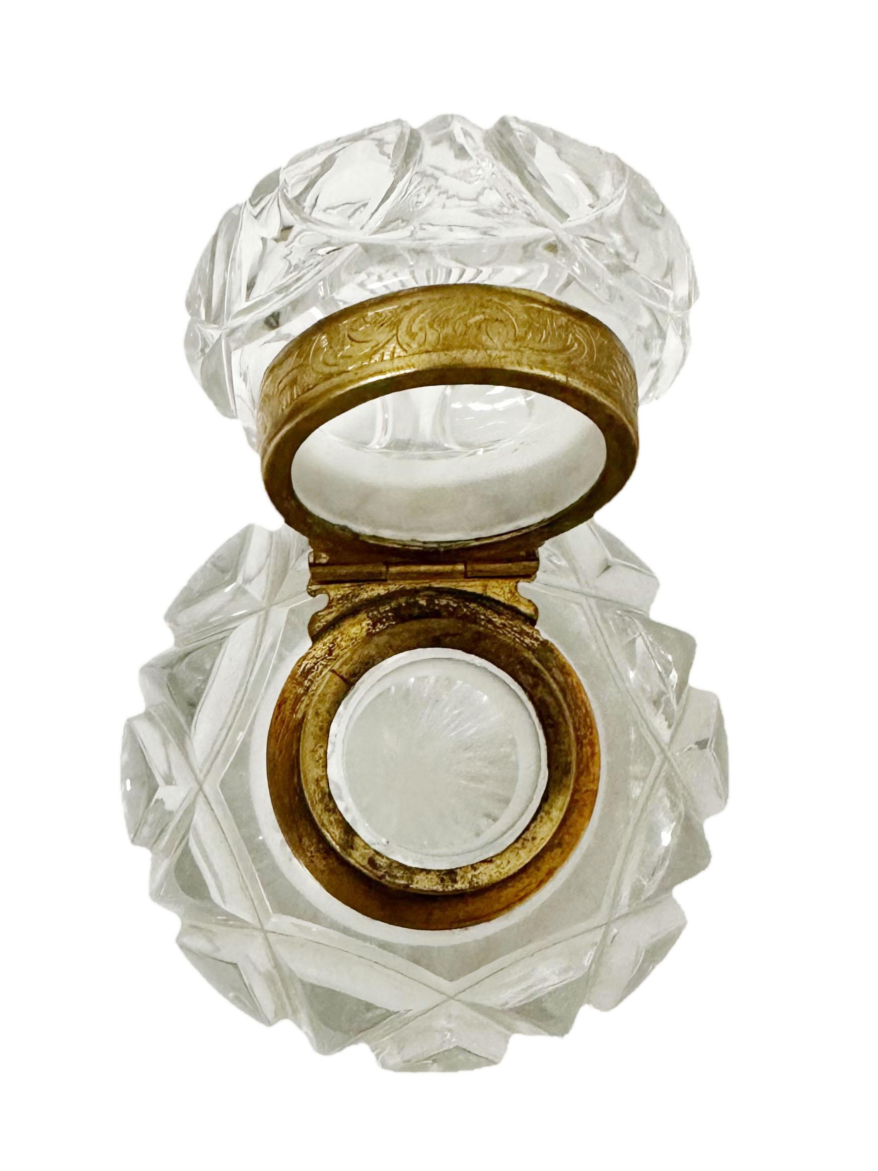 A Baccarat crystal inkwell with decorated bronze. Circa 19th century, France. The interior is two inches deep and the opening is one inch wide.