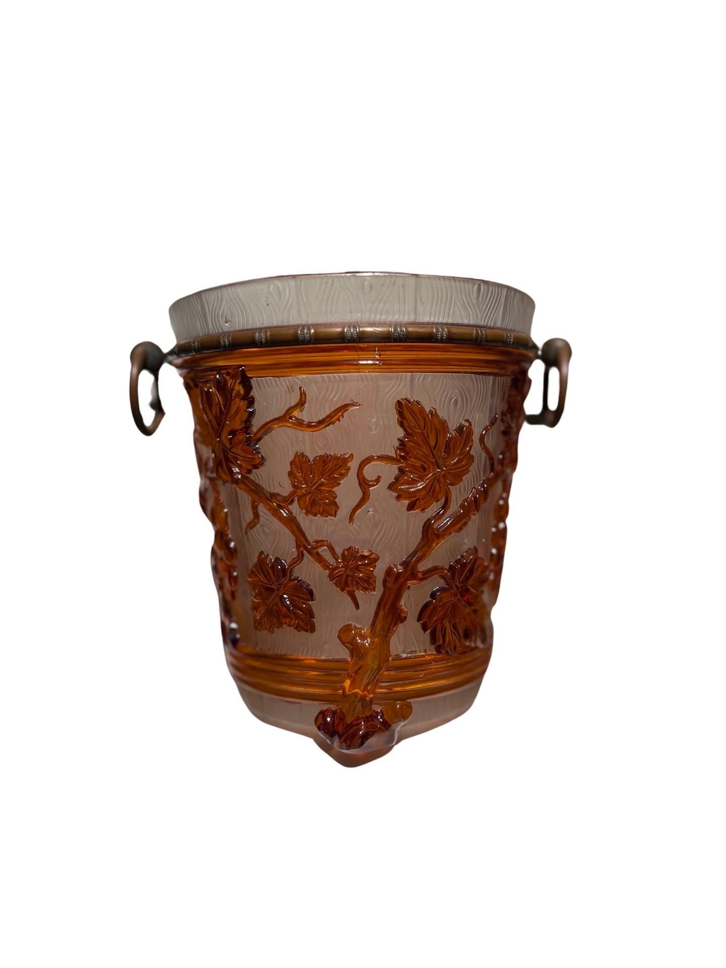 Baccarat, circa 1860.

A 19th Century Baccarat Ormolu Mounted Grape Vine Pattern Ice or Champagne Bucket made of pressed French glass showcasing a beautiful grape leaf and vine motif to exterior and a faux bois textured surface. The interior is