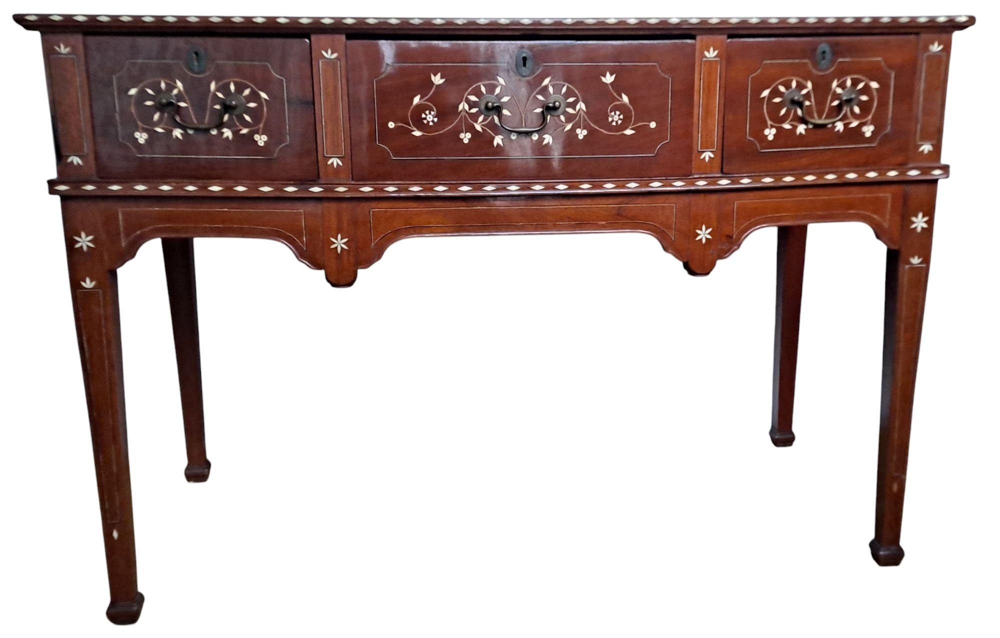 Rare late 19th century Baliuag/Baliwag Sheraton style alter table made in the Philippines.  Can be used as a desk or sideboard.
Narra wood (rosewood native to the Philippines) with carabao bone inlay in a diamond and floral pattern, three drawers,