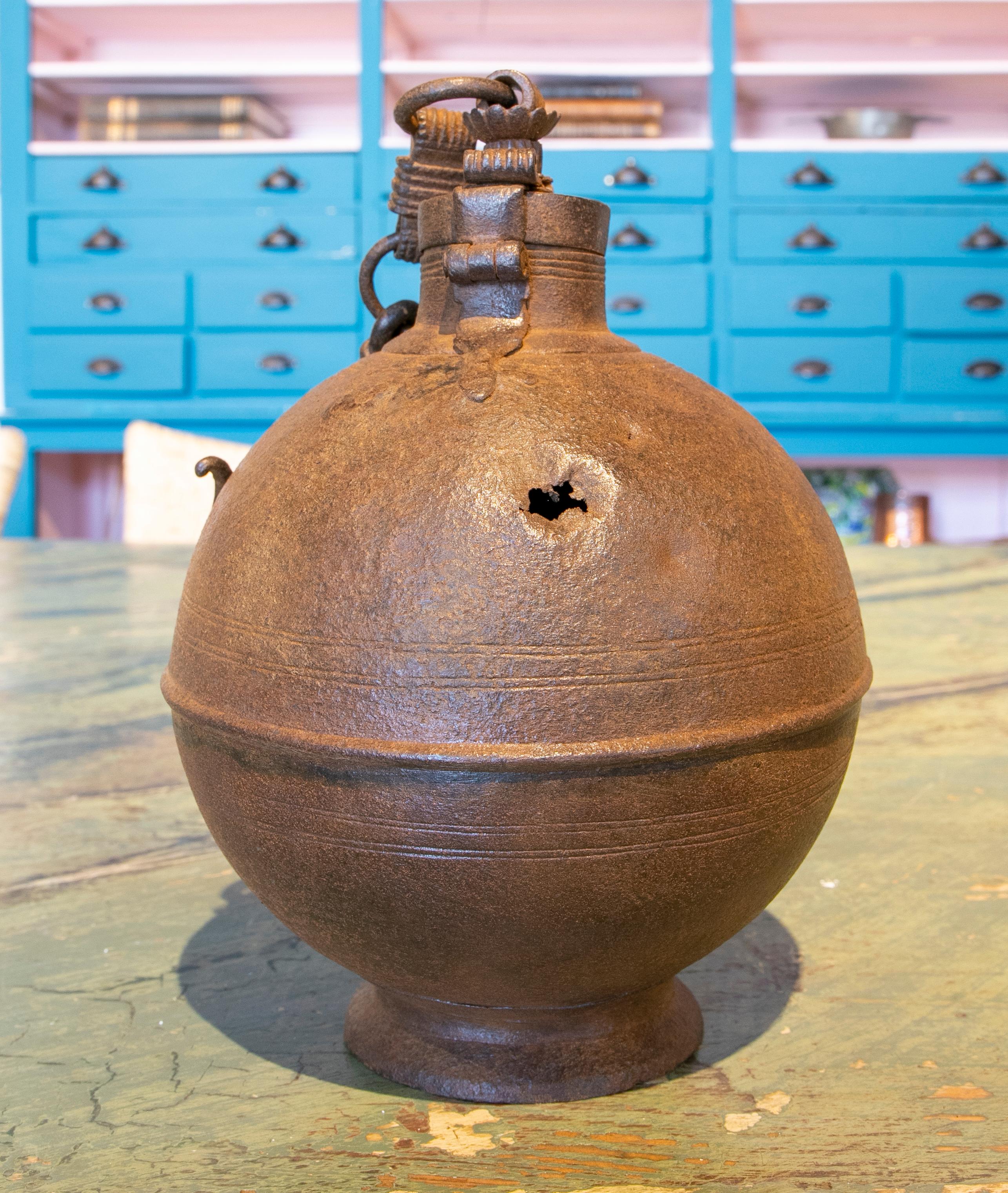 19th century ball-shaped iron box with hook for hanging and a lock.