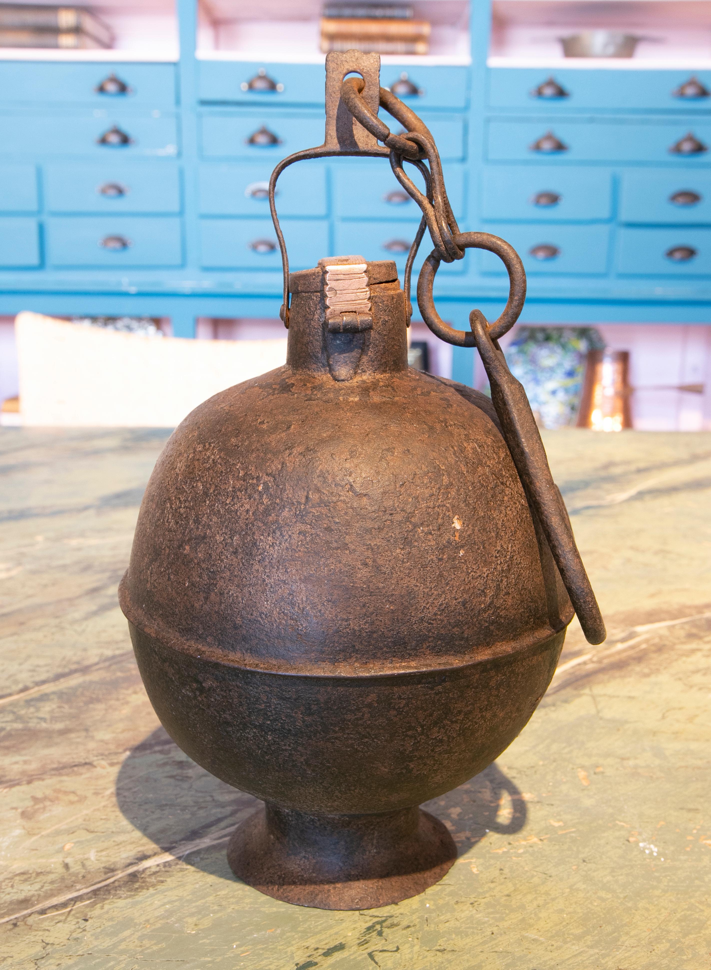 19th century ball-shaped iron box with hook for hanging and a lock.